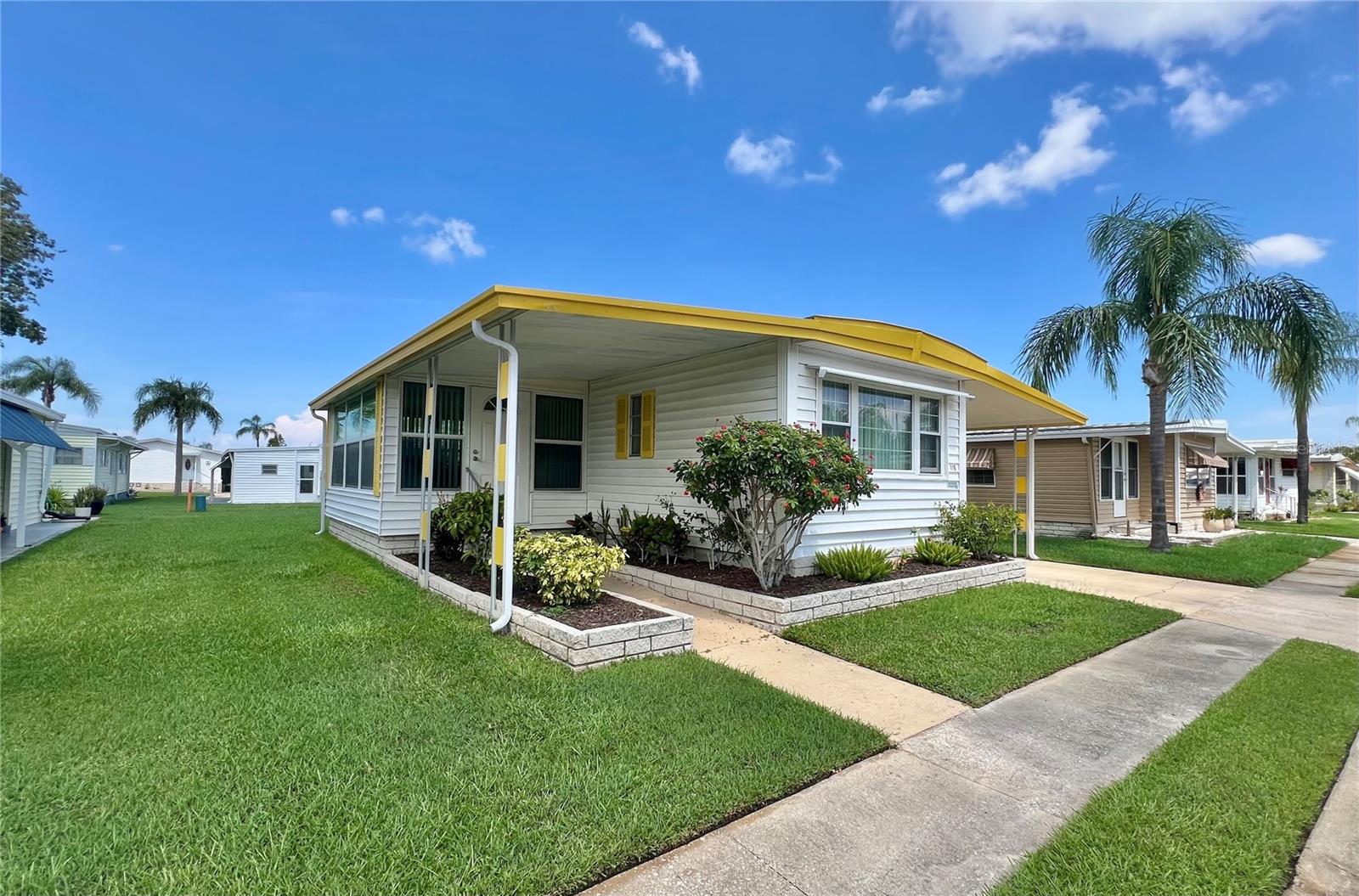 Pet Section – Affordable 2 Bedroom, 2 Bath Home in the Premier 55+ Fairway Village Community. Welcome to Fairway Village, where vibrant living meets serene surroundings—and this charming 2-bedroom, 2-bath single-wide home offers the perfect opportunity to enjoy it all. Located in the pet-friendly section of this prestigious 55+ community, this well-maintained residence is thoughtfully priced at just $89,900, offering incredible value in an upscale, resort-style setting. The exterior is in excellent condition, featuring vinyl siding, a durable roof-over system, A/C and Vapor Barrier installed in 2020 and newer double-pane windows that enhance energy efficiency and curb appeal. Inside, the split-bedroom floor plan ensures optimal privacy—ideal for hosting guests or accommodating a home office or hobby space. While the home may benefit from a few cosmetic updates and possibly a new refrigerator, it is a ready for your personal touch. This property is being sold completely “AS IS,” making it an ideal choice for a snowbird getaway, a full-time residence, or a savvy investment opportunity in a highly sought-after community. Community Features That Set Fairway Village Apart: Fairway Village is more than a place to live—it’s a lifestyle centered around connection, activity, and peace of mind. Enjoy exclusive access to: Private 9-hole, par-3 golf course with lakefront fairways and a putting green, 5-acre lake for scenic views and catch-and-release fishing, Two resort-style swimming pools and hot tubs for year-round relaxation, Eight covered shuffleboard courts for friendly competition. Brand new 19,000+ sq. ft. clubhouse (opened in 2022) with: 700-seat auditorium and ballroom, Commercial-grade kitchen and performance stage, State-of-the-art fitness center, Library, card room, billiards room, Conference rooms and cozy sitting areas, Free Wi-Fi throughout, A Community That Feels Like Family. Fairway Village is known for its active and welcoming atmosphere, hosting over 50 social events per year that foster friendships and lifelong memories. From fitness classes and dances to hobby clubs and golf tournaments, there’s always something to look forward to. Affordable & Worry-Free Living, 2025 Monthly Maintenance Fee: $401 (Includes water, sewer, lawn care, pest control, curbside trash pickup, high-speed internet, and 220+ Spectrum TV channels) Optional Unlimited Golf Membership: $440/year + tax, Low greens fees available for residents who choose not to join, Community is private and not open to the public. If you’ve been searching for a well-priced home in a friendly, amenity-rich community where you can enjoy the Florida lifestyle to the fullest—this is the one. Whether you're escaping the cold northern winters or seeking a peaceful, year-round retreat, this home has the potential to be something truly special. Don’t miss out—call today to schedule your private showing. Your next chapter starts here at Fairway Village.