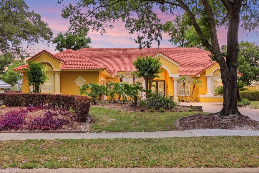 Welcome to 7407 Park Springs Cir, a luxury single-story pool home in the exclusive gated community of Park Springs—an intimate Orlando–Windermere area enclave of just 42 homes surrounded by mature oak trees and timeless curb appeal. Designed for both everyday comfort and elevated entertaining, this 4-bedroom, 3.5-bath residence features a tile roof, soaring 12-foot ceilings, rich wood flooring, detailed crown molding, an open split floor plan, and a spacious living area anchored by a beautiful wood-burning fireplace. The chef’s kitchen is appointed with JennAir appliances, granite countertops, and direct sightlines into the main living space, creating a seamless flow for gatherings. Step through the French doors into your own private resort-style retreat featuring a screened coquina-tiled pool deck, PebbleTec pool and heated spa, tranquil waterfall features, gas outdoor fireplace, summer kitchen with grill, covered lanai, and rear privacy wall for a true tropical oasis. The layout includes generously sized bedrooms, a convenient pool bath, and a Jack-and-Jill style connection between secondary bedrooms, offering comfort and functionality for family or guests. Park Springs residents enjoy a private community park with basketball courts, swings, play area, and gazebo picnic space, all while being minutes from Windermere, Dr. Phillips, Restaurant Row, Universal Orlando, Mall at Millenia, major highways, shopping, dining, and Orlando’s world-class attractions. Rarely do homes in this private gated community become available—schedule your private showing today.