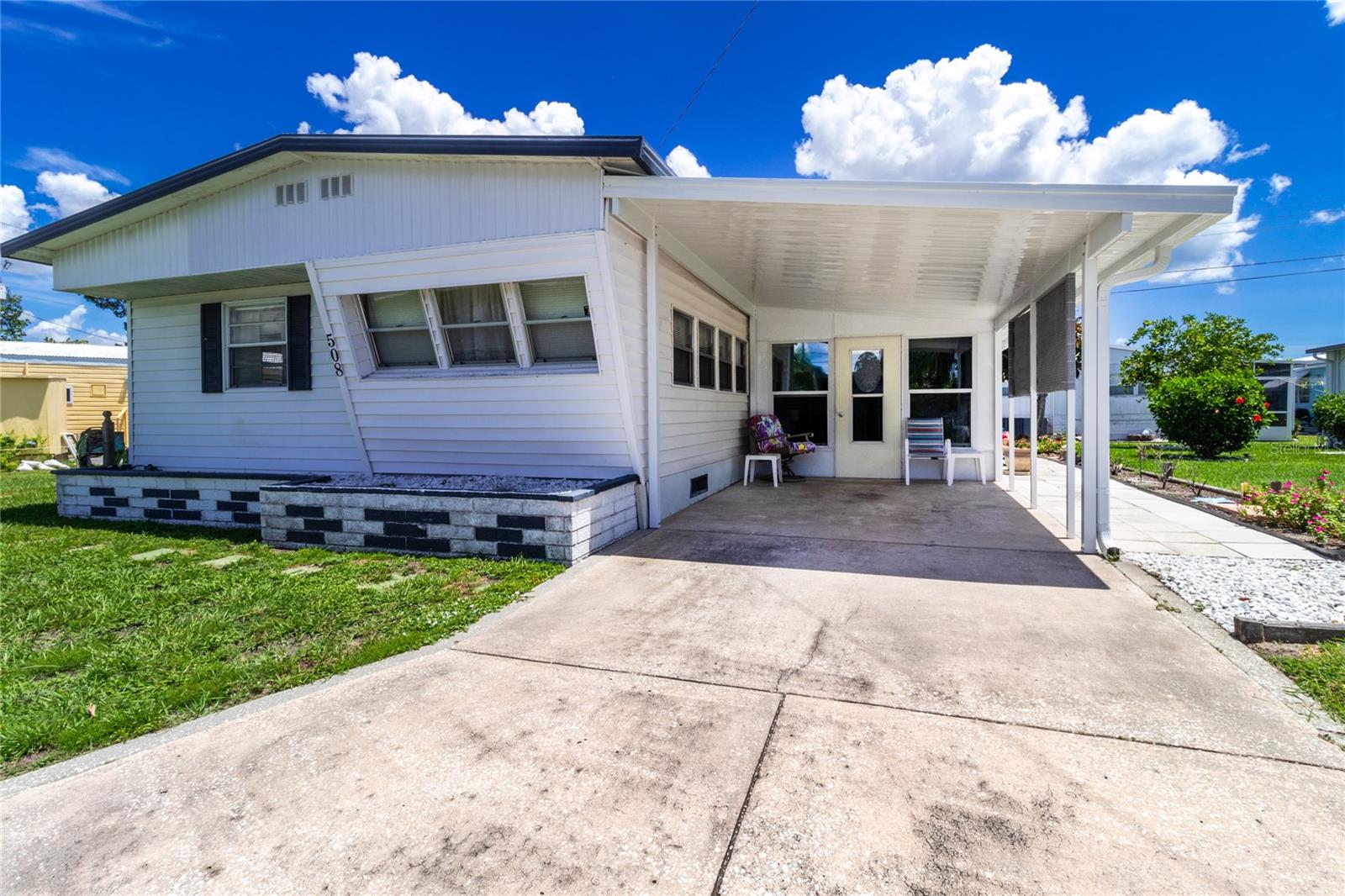 *Rare Non-Aged Restricted* Welcome to low-maintenance living with a splash of fun in Fair Lane Acres—a lively community where neighbors quickly become friends. This move-in ready 2-bedroom, 2-bathroom mobile home offers 1,022 square feet of inviting space designed for comfort and connection. Step into a large living room with newer carpet and plenty of room to host or simply kick back and relax. The dining area seamlessly connects for easy entertaining. The primary bedroom features newer carpet and a generous walk-in closet. A second bedroom offers flexibility for guests or creative pursuits. An enclosed porch off the carport provides even more space—ideal for morning coffee or mild-weather lounging. Practical perks include covered parking, a sizable storage shed with washer and dryer included, and a second bathroom for added convenience along with a second shed for lawn equipment and additional storage. Best of all, you’ll own the land—no lot fees to sneak up on you—and enjoy modest monthly dues that cover water, sewer, and access to an exciting lineup of community amenities.
From the pool to the pickleball courts, shuffleboard games to lively dinners and dances, there's always something happening in Fair Lane Acres. But don’t worry—quiet moments with a good book, or impromptu porch chats with neighbors, are just as welcome. Conveniently located close to grocery stores, public transit, parks, and sunny Gulf beaches, you’re never far from what matters. Whether you're seeking connection, convenience, or charm—all roads lead here. Don’t miss your chance to join this vibrant community. Schedule your visit today!