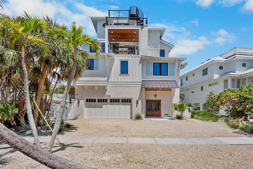 Just steps from the sugar-white sands of Siesta Key Beach and the vibrant Village, this brand-new coastal retreat is where luxury meets laid-back island living. Designed for unforgettable gatherings, the home offers eight bedrooms and eight-and-a-half baths, blending style, space, and sophistication throughout.
The backyard feels like your own private resort, complete with a sparkling pool, in-ground spa, and waterslide surrounded by lush tropical landscaping. After a day at the beach, rinse off in the outdoor shower, then head up to the rooftop deck for sunset views over the Gulf.
Inside, bright open spaces flow effortlessly from the living room to the designer kitchen featuring stainless-steel appliances, a wine fridge, and a large island perfect for entertaining. Every bedroom has its own ensuite bath—seven with king beds and one fun bunk room ideal for guests.
An elevator, laundry area, foosball table, and thoughtful coastal touches throughout make this home as functional as it is beautiful. Just a two-minute walk to the sand and Siesta Key Village, this property offers the ultimate combination of location, luxury, and lifestyle.