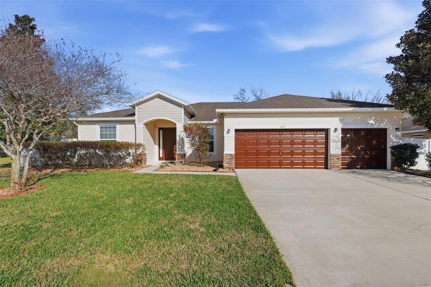 This immaculately kept .28-acre estate home in Deltona’s most prestigious community of Lake Baton Estates on a quiet cul-de-sac features 4 bedrooms, a 3-car garage, an extended screened lanai in the fully fenced backyard, a 22-kw natural gas whole-house generator, and a large bonus room with tray ceilings. The split floor plan offers soaring ceilings and an open layout that feels even more spacious. The gourmet kitchen features stainless steel appliances including a natural gas range, granite countertops, abundant 42” cherry wood cabinets with crown tops and custom tiled backsplash, plus a huge island and breakfast bar with overhead pendant lighting. The 18’ x 18’ primary suite with tray ceilings offers private screened lanai access, dual walk-in closets, and a spacious ensuite bath with walk-in shower, water closet, dual granite-topped vanities, and a garden soaking tub. The 13’ x 15’ bonus room with tray ceilings could easily serve as a 5th bedroom. An 8-stage reverse osmosis system with UV purifier supplies interior water to much of the home, with the refrigerator, water cooler, and coffee maker plumbed to the system. A newer exterior whole house water softener and filtration system is also included. Additional features include brand-new interior and exterior paint (2026), matching granite countertops in bathrooms, an 8-camera surveillance system with no subscription, underground utilities, no history of flooding, indoor laundry/utility room, and fully irrigated landscaping. The huge screened extended lanai and exterior paved area offer ideal spaces for morning coffee or afternoon barbecues with the privacy of vinyl fencing. Seller receives credits from Wind Mitigation report. Located within a few miles of Publix, restaurants, Walmart, and I-4. Ask your Realtor® for the unbranded virtual walking tour. Measurements are approximate and should be independently verified.