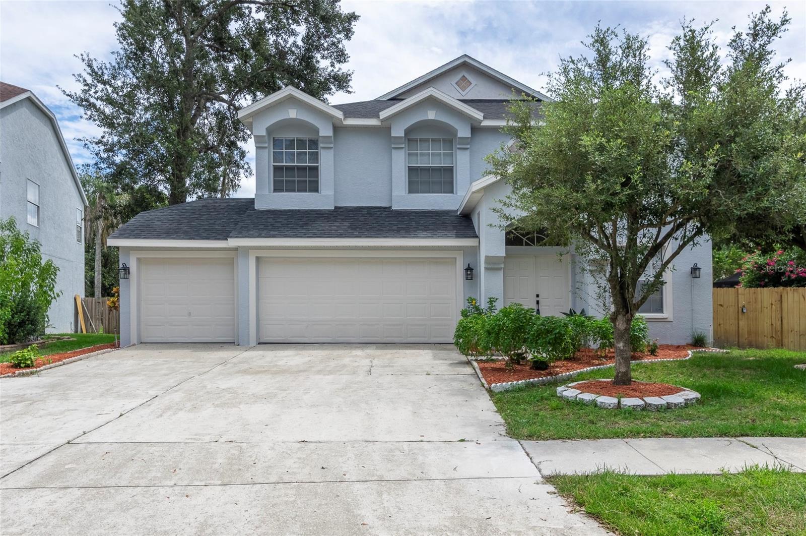 Welcome to Your Florida Dream Home! This completely remodeled 5-bedroom, 3-bath gem has been upgraded from top to bottom and is move-in ready. Freshly painted and featuring a brand-new 2025 AC unit, it is located in the highly sought-after Erin Arbor community of Bloomingdale East, renowned for its top-rated schools and strong sense of community. Inside, enjoy soaring ceilings, gleaming tile floors throughout the first level, and abundant natural light. A striking modern chandelier highlights the staircase, while the kitchen serves as the heart of the home—offering new cabinets, quartz countertops, stainless steel appliances, and highchair seating space—all overlooking the open living and dining area. Upstairs, new plank laminate flooring adds warmth and style. Each of the three bathrooms has been recently renovated with contemporary finishes, including LED mirrors, quartz counters, sleek cabinets, designer tile showers, and modern toilets. The primary suite features a spa-like retreat with a massive shower, luxurious soaking tub, frameless glass door, double vanity, and two walk-in closets—one accented with a chic barn door. The oversized backyard is fully enclosed with complemented by tropical fruit trees for a serene outdoor escape. Don’t miss your chance to own this one-of-a-kind Florida dream home!