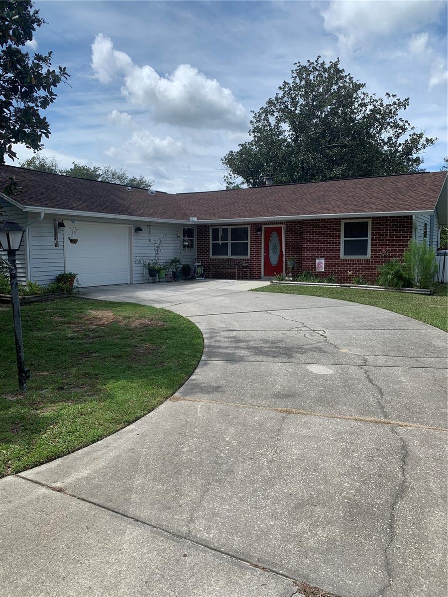 Step into this charming, spacious 3-bedroom, 2-bath home on a quiet street in the heart of Homosassa. The open living area features stunning vaulted beam ceilings and a cozy wood burning fireplace that creates a warm and inviting atmosphere. The updated kitchen overlooking the living and dining areas boasts sleek stainless steel appliances, perfect for everyday cooking or entertaining. Enjoy reading in the bright and airy sunroom that opens up to the back yard patio that is an ideal space for relaxing with your morning coffee or hosting guests. The large beautifully landscaped backyard is fenced with a separate garden area, storage shed, and plenty of space to relax or play. Major updates include fresh interior paint, a new complete septic system (2021), new garage door (2021) and a new roof (2024), providing peace of mind for years to come.. This home provides the perfect blend of comfort, style, and functionality and is ready to welcome its new owners!