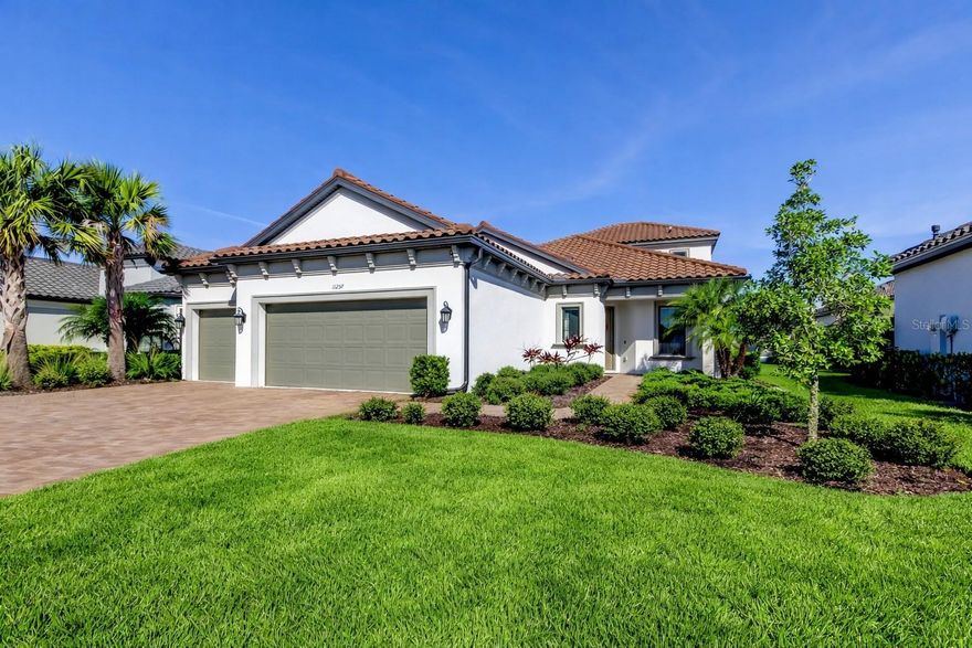 Welcome to this beautifully maintained 3 bedroom, 3.5 bathroom, 3 car garage home located in the exclusive gated community of Esplanade at Starkey Ranch. Built by Taylor Morrison in 2020 and offered by the original owners, this rare two story residence offers 2,740 square feet of thoughtfully designed living space with peaceful waterfront views and no flood insurance required by lender.

As you enter, you will immediately notice the bright open layout enhanced by 10 foot tray ceilings, crown molding, and expansive sliding glass doors that bring in an abundance of natural light. The gourmet kitchen is the heart of the home, featuring stone countertops, a large center island, gas range, stainless steel appliances, and a spacious walk in pantry, perfect for both everyday living and entertaining.

The first floor owner’s suite offers a private retreat with serene water views, dual granite vanities, a large walk in shower, and an oversized closet with additional storage tucked under the stairs. A secondary bedroom with its own ensuite bath is also located downstairs, along with a convenient guest half bath.

Upstairs, you will find a generous bonus room, a third bedroom, and a full bathroom, creating the ideal setup for guests or multi generational living.

Step outside to the screened lanai and enjoy tranquil water views, perfect for relaxing or entertaining. The paver driveway and walkway add to the home’s curb appeal and overall charm.

Esplanade at Starkey Ranch offers a low maintenance (lawn maintenance, fertilizing, mulch replacement, hedge trimming, and palm care INCLUDED in fees), resort style lifestyle with amenities including a clubhouse, 24 hour fitness center, spa, lap and resistance pools, pickleball courts, tennis, and more. Residents also enjoy access to all of Starkey Ranch’s amenities including multiple community pools, playgrounds, over 20 miles of scenic trails, dog parks, a kayak lake, and a top rated K through 8 STEM school.

Conveniently located just 30 minutes from Tampa International Airport and the Gulf beaches, this meticulously maintained home is truly move in ready and offers the perfect blend of luxury, comfort, and lifestyle.