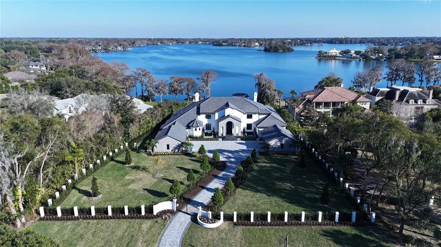 Welcome to Maison Du Lac, nestled within the sought after Winter Park chain of lakes, this magnificent 11,668 sq ft estate presents an unparalleled living experience on 2.73 lush acres. With meticulous attention to detail and an expansive layout, this home offers 5 suites plus an opulent master wing, complete with its own office, sauna, and gym, ensuring privacy and luxury at every turn.

Enter through the 14-foot custom iron front door, a statement piece valued over $50K, to discover a world of refined elegance. The main great room, illuminated by a "luxury hotel" crystal chandelier worth over $100K, sets the tone for an interior professionally designed with custom artwork. State-of-the-art energy-saving windows bathe the space in natural light, highlighting the exquisite craftsmanship and state-of-the-art appliances that adorn the home.

The master wing is a sanctuary of tranquility, featuring a secret safe room within the master bathroom for ultimate privacy. His and hers massive walk-in closets offer lavish conveniences, including a built-in watch winder and a special shoe closet for her, catering to the most discerning tastes.

This estate is an entertainer’s paradise, boasting a summer kitchen, a bar, and entertainment areas designed for hosting memorable gatherings. The brand new, completely rebuilt dock invites leisurely days by the lake, while the 6-car garage accommodates any automotive enthusiast.

This residence combines modern convenience with peace of mind, equipped with a state-of-the-art smart home system and an alarm monitoring system. The privacy gates ensure a secluded retreat, making this home a secure haven of luxury.

Over $3 million in renovations, including a brand new $350K roof and landscaping exceeding $400K, have transformed this estate into a masterpiece of design and comfort. The enormous walk-in butler pantry and professional interior design elevate the home’s functionality and aesthetic appeal.
 
This estate is more than a home; it’s a lifestyle offering, professional interior designed by MAX Home Design crafted for those who seek the ultimate in luxury, privacy, and lakeside living. Welcome to your exclusive retreat on Lake Maitland, where every detail reflects your desire for the extraordinary. Bedroom Closet Type: Walk-in Closet (Primary Bedroom).