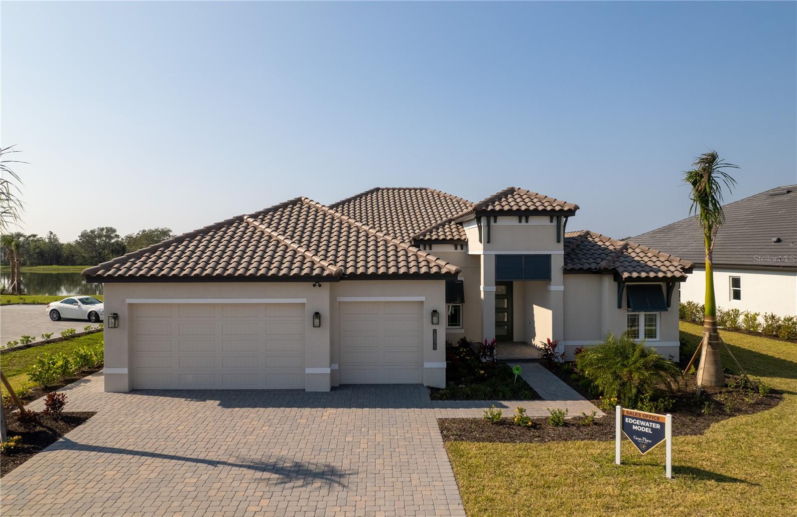 Welcome Home to the Edgewater Model Home with Leaseback at Gran Place, a Sam Rodgers Homes exclusive enclave of only 42 homes. The Edgewater Model is 2,872 Sq. Ft. and features 3 Bedrooms, 3 Baths with Bonus Room & 3 Car Garage with Paver Driveway, Outdoor Kitchen, Heated Pool & Spa with oversized Paver Lanai Deck & Cage. Enjoy a magnificent sunset from the lanai overlooking a glistening lake and private natural preserve. Entertain family and friends in the open Great Room plan with up to 15’ Ceilings, 8’ Doors, Impact Performance Windows and Doors, Gourmet Kitchen featuring large center island with Quartz countertops, built in GE Stainless Steel appliances and Dura Supreme wood cabinets with soft close doors & drawers. The cabana, positioned on the other side of the pool, offers a full outdoor kitchen, a dining area, a pool bath and a living room with a stone-clad gas ?replace and TV. Gran Place is a natural gas community and is a chef’s dream. If you’re not already familiar with Sam Rodgers Homes, not to worry, the quality is second to none and speaks for itself.
Residents of this Venice, Florida address will enjoy a wide variety of waterfront shopping, dining, entertainment, and amenities within the 175-acre Downtown Wellen District. Downtown Wellen will include retail shops, waterfront dining and additional restaurants, a town hall, a playground and splash pad, a food truck arena, a 3-mile health and wellness trail, and an outfitter equipped with e-bikes, paddle boards, and kayaks for residents use on the activity lake. Wellen Parks 20+ miles of nature and fitness trails offer robust outdoor recreation and ample opportunity for residents to enjoy outdoor living while connecting with neighbors. Major highways are easily accessible from Gran Park at Wellen Park, offering homeowners convenient access to world-renowned beaches, Downtown Venice, and Downtown Sarasota. Gran Place is conveniently located near A-rated Sarasota County schools.