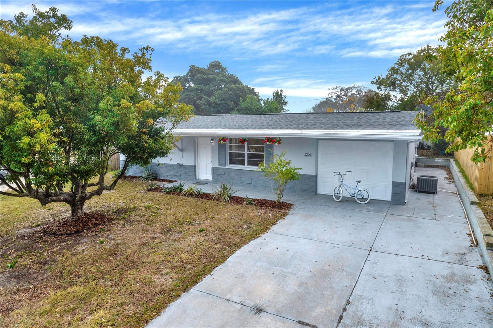 One or more photo(s) has been virtually staged. One or more photo(s) has been virtually staged. NO FLOODING and NO FLOOD ZONE HERE! Photos have been virtually staged. This beautifully UPDATED 3-bedroom, 2-bathroom home offers the perfect blend of modern convenience and cozy charm with New Flooring. Enjoy a bright and spacious living room featuring brand-new modern-style cabinets with LED lights inside. The Modern Kitchen is adorned with beautiful newer cabinetry, Granite countertops, a stylish backsplash, and new appliances. A rich wooden island adds an element of aesthetic and elegance. The home boasts TWO Remodeled Bathrooms, complete with beautiful new vanities, updated lighting, stylish tile, and more—allowing you to move in and enjoy all the upgrades already done for you! The ENTIRE exterior and interior have been freshly painted, ensuring a CLEAN and refreshed look. A NEWER FENCE provides privacy, while mature landscaping creates the perfect outdoor setting for pets and activities. Additionally, the freshly painted 1-car garage includes a washer and dryer for your convenience.