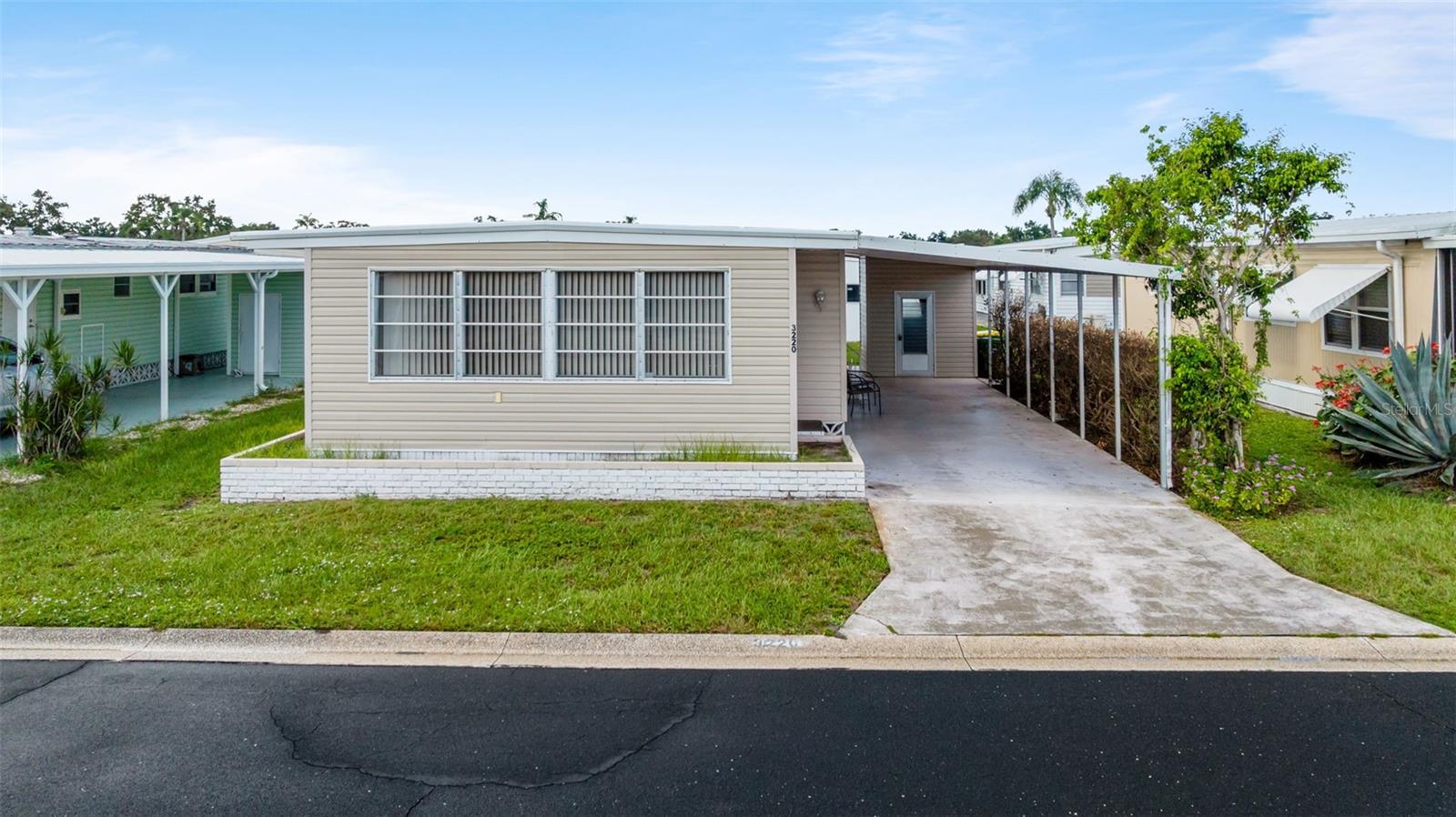 Welcome home to 3220 Sweet Gum Terrace located in Oakwood Manor, a gated 55+ community located in Sarasota, FL where you enjoy all that SWFL has to offer. This home is the perfect winter retreat, full time home or investment opportunity. Interior floor plan includes two bedrooms, two bathrooms, kitchen, dining room, living room and interior laundry for added convenience. On the exterior you'll love having the long driveway, carport and 48sq ft storage shed. Short distance to all the community has to offer including swimming pool, hot tub, shuffleboard, mini golf, fitness center and clubhouse. Home being sold partially furnished as shown, no golf cart. Perfect opportunity to renovate and make it yours. Short driving distance to restaurants, shopping, golf courses, beaches, airport and more.