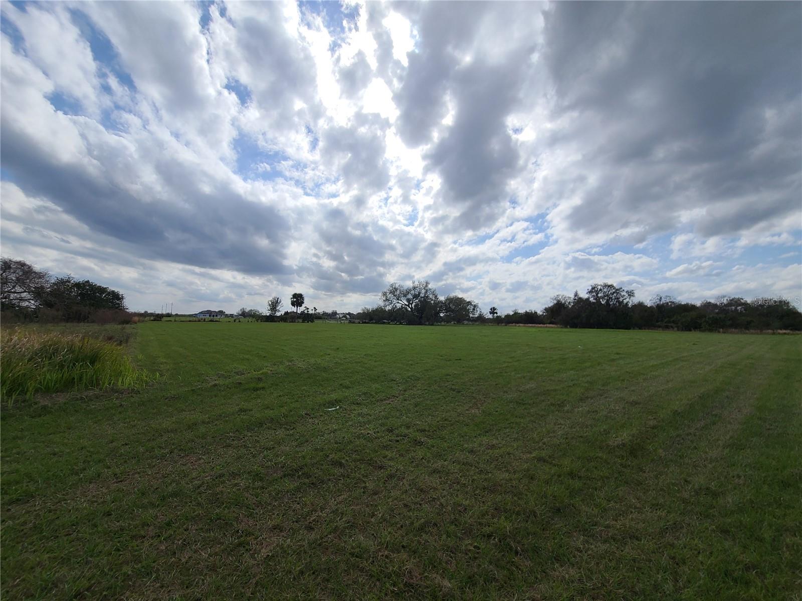 2.79 acres of cleared, high and dry vacant land located in Flood Zone X with majestic Oak Tree in back SW corner of property. No wetlands; 100 percent buildable. When reviewing photos, this property is the flag-shaped parcel of land bordered in red. Land is ready to build your custom estate with the builder of your choice. Recently installed culvert to access property from your own private drive. Located on Indianola Rd, a quiet, paved road off Kissimmee Park Road (KPR). Property is a short drive from St Cloud’s proposed new Urban Center development and Florida Turnpike’s new diamond exchange already under construction at New Nolte Road and ~ 25-minutes from Orlando MCO Airport and Lake Nona. Zoning allows for both a primary estate plus a separate in-law house to be built on this parcel with separate addresses allowed for each dwelling. Million-dollar estates located a few houses down the street within view from this property; a nursery borders the property's South side.