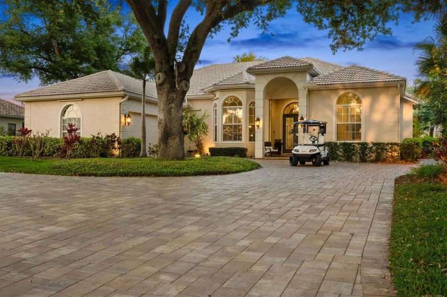 Located in the gated Boca Royale Golf & Country Club, this lakefront residence offers water views from both the front and rear—perfect for enjoying Florida sunsets. Privately positioned on an oversized homesite designed for indoor-outdoor living, the home features mature palms and tropical landscaping, a screened lanai with an elegant paver deck, saltwater pool, and fully equipped outdoor kitchen with gas grill and dual refrigerators, creating a private, resort-inspired retreat. As evening falls, curated landscape lighting illuminates the property and architectural details, casting a warm glow and enhancing the home’s captivating nighttime ambiance.

Inside, sophistication and comfort blend effortlessly. Glass French doors open to a light-filled interior featuring soaring ceilings, crown molding, plantation shutters, and expansive tile flooring throughout the main living areas. The kitchen is open to the oversized family room, perfect for entertaining is appointed with stainless steel appliances, double ovens, a French-door refrigerator, cooktop, 42-inch custom cabinetry, granite countertops, and a spacious center island with abundant storage. A raised breakfast bar opens seamlessly to the main living area with a custom entertainment center and direct lanai access, ideal for relaxed yet elegant living.

The private primary suite is a true retreat, offering direct access to the lanai, plantation shutters, custom wood accent wall, dual walk-in closets, and a spa-inspired bath with a soaking garden tub, walk-in shower, dual vanities, and a private water closet.

Guest accommodations on the opposite side of home, including 2 large bedrooms with hall bath and in the back of the home off the lanai is a versatile room with custom built-ins that offers a flexible space for a 4th bedroom, executive office, or private guest suite.

Additional highlights include NEW PAVERS in front driveway and side walkway, an oversized laundry room with extensive storage and utility space, plantation shutters throughout, a chic half bath for guests, and an oversized 2.5 CAR GARAGE with dedicated golf cart storage. Storm Smart Wi-Fi-enabled hurricane screens at the lanai and front entry, along with a GENERAC WHOLE HOME GENERATOR, provide added comfort and peace of mind.

Ideally located just a short golf cart ride from the desired Boca Royale Golf & Country Club, residents enjoy access to an exclusive members-only lifestyle featuring a championship Gordy Lewis-designed golf course, tennis and pickleball courts, fitness and wellness amenities, fine dining, and a vibrant social calendar. Also, future plans of direct access to Wellen Park through the new Boca East section.

This is more than a home—it is a statement of privacy, luxury, and elevated Florida living.