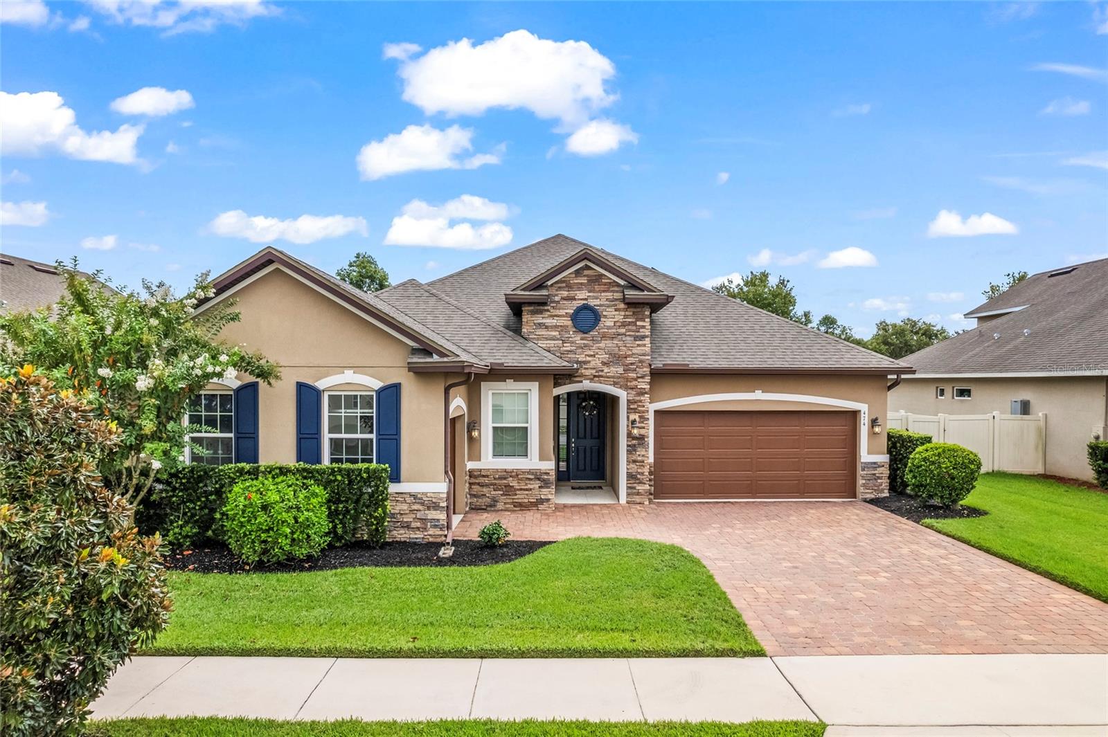 One or more photo(s) has been virtually staged. Welcome to this stunning home in the desirable gated community of Roper Reserve, just 5 minutes from Downtown Winter Garden and the Winter Garden Village. This property truly has it all, from gorgeous pond and greens space views with no rear neighbors, to a Primary Suite on the first floor, custom built in closest and dining space, and a beautiful oversized island with custom extended cabinets in the kitchen. The yard is completely fenced offering privacy without obstructing the wonderful view. The 2 car garage with an additional single bay garage guarantees plenty of parking and garage space. The kitchen is equipped with a walk in pantry, loads of cabinet space, and gas stove for perfect cooking every time. Throughout the home, you’ll find solid surface counters, roll-down shades, and an abundance of natural light enhancing each space. The expansive back patio is ideal for entertaining, offering plenty of room to host even the largest gatherings. With 3 bedrooms on the main floor and a 4th along with en-suite on the second floor you are guaranteed to have enough space for everyone. Solar Panels are Paid Off, EV charging station, and Water Softener system included. Quick and Easy access to 408/429. Schedule your Showing Today!