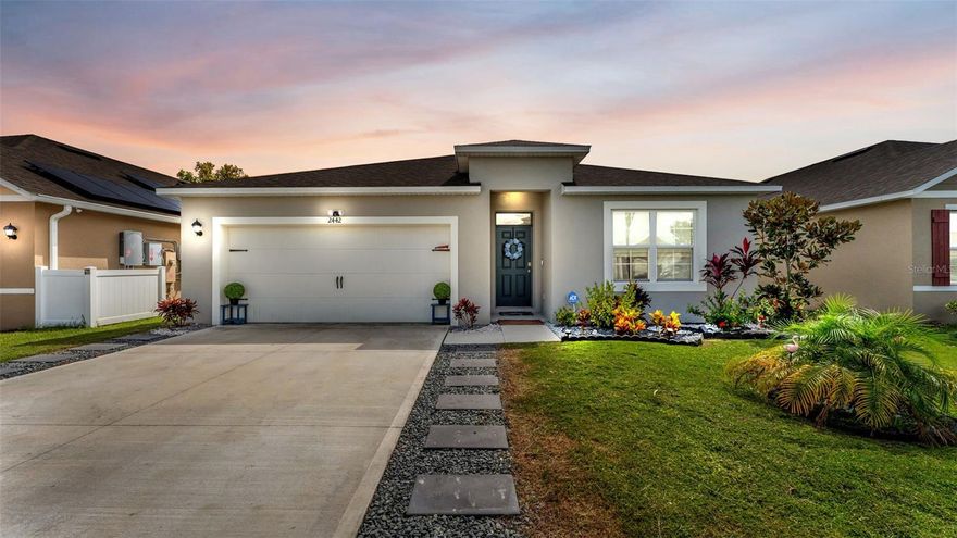 Welcome to 2442 Taloncrest Ct, located in the desirable Eagle Hammock community of Eagle Lake, FL! Built in 2023, this beautifully maintained 4-bedroom, 2-bathroom home offers modern comfort and style. The open-concept kitchen features stainless steel appliances, an island, ample cabinetry, and generous counter space — perfect for both everyday living and entertaining. Enjoy the spacious primary suite complete with a walk-in closet and an ensuite bathroom featuring a sleek walk-in shower. Additional highlights include a separate laundry room, and a fully fenced backyard with sliding doors leading to a covered patio — where you can relax and take in waterfront views of the pond. All outdoor furniture is included with the sale! Conveniently located just minutes from Lake McLeod, shopping, dining, and more. This move-in ready home combines modern finishes, peaceful surroundings, and unbeatable value.