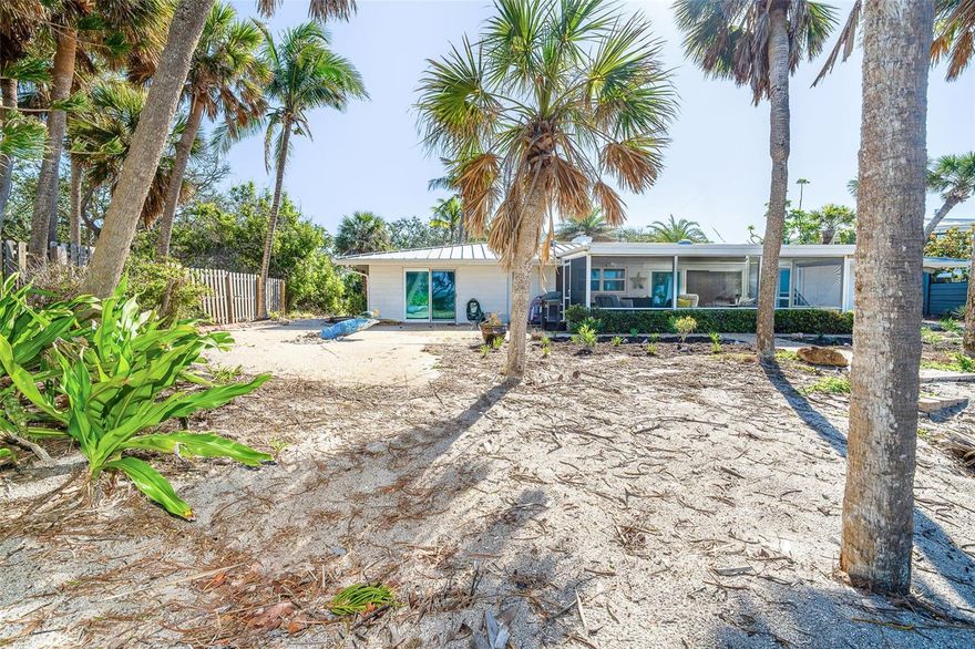 Welcome to 7820 Manasota Key! This charming beachfront cottage is perfectly situated between Sarasota and Naples on Florida’s tranquil Gulf Coast, boasting 100 feet on the Gulf of Mexico. Reminiscent of classic Old Florida, this home offers a private, unhurried lifestyle where relaxation comes naturally. Designed for both comfort and durability, the property features impact-resistant hurricane doors and windows facing West,  a sturdy metal roof, three spacious bedrooms, and two bathrooms. The kitchen is beautifully appointed with granite countertops and a breakfast bar, while the living room invites warmth with its cozy wood-burning fireplace. Perched on one of the highest elevation points on the key, the home is safeguarded by a rock revetment, offering peace of mind and long-term protection. Notably, it sustained no damage during recent hurricanes. The main living area showcases an open floor plan that highlights breathtaking Gulf views. Step outside onto the expansive gulf-front patio or relax in the screened lanai, where you can take in stunning water views. A detached two-car garage adds convenience and extra storage. Take a stroll down sandy pathways to the shore, where you can bask in the beauty of warm turquoise waters, collect seashells and shark’s teeth, or simply soak in the serenity of coastal living.