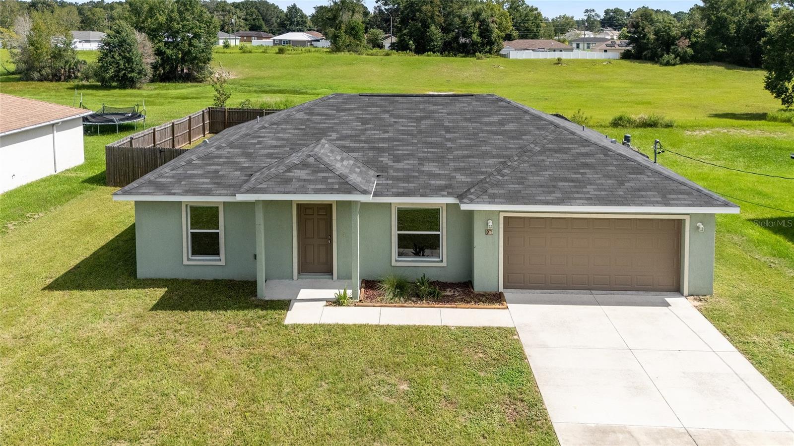 This beautiful 2020-built home offers a perfect blend of elegance and coziness. Inside, you'll be greeted by vinyl floors and vaulted ceilings, creating a bright and inviting atmosphere. With 3 bedrooms, 2 bathrooms, a wooden fenced in yard, and an attached 2-car garage, this concrete block and stucco home features: Granite counters in the kitchen and bathrooms, Walk-in master bedroom closet, 0.23 acre lot in Silver Springs Shores. The open concept and split bedroom floor plan offer ample space and privacy, making it ideal for relaxation and entertainment. Enjoy outdoor activities and create your own private retreat on your expansive property. This home is conveniently located near amenities, with easy access to shopping, dining, and entertainment options. As a newer home, it offers modern features and construction quality. Don't miss out on the chance to see this home - schedule your showing today!