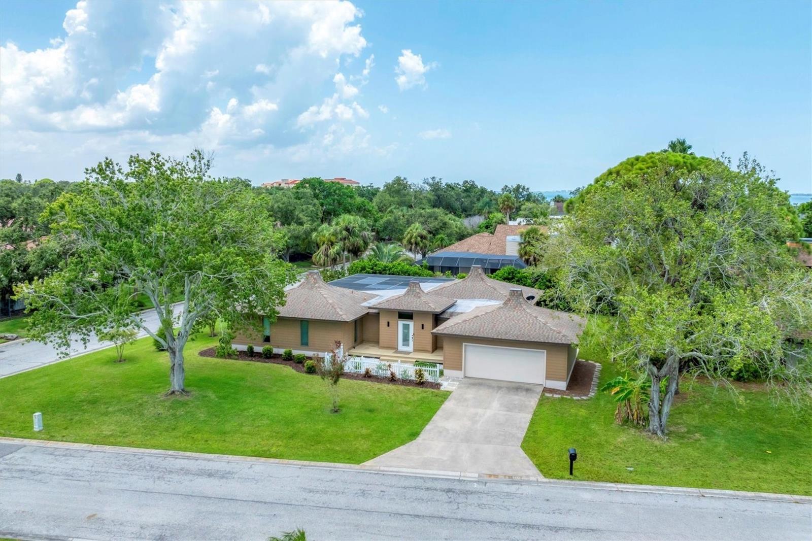 Exquisite Mid-century Modern gem on an oversized corner lot just minutes from IMG Academy. Stunning renovations enhance this home’s iconic architectural style, showcasing clean lines, expansive windows and sliders, open floor plan, and seamless connection to nature—all culminating in an elegant and luxurious living space.
The expansive great room is filled with natural light and opens directly to the screened lanai, creating effortless indoor-outdoor flow ideal for entertaining. At the heart of the home, the custom kitchen boasts high-end Italian cabinetry, quartz countertops, premium Miele appliances, and a striking waterfall island with bar seating. The dining area sits just off the kitchen, perfectly integrated into the open layout for easy, elegant gatherings.
The primary suite is a peaceful retreat with direct access to the lanai and a spa-style bathroom featuring a sleek vanity, lighted mirror, and walk-in shower. Two generously sized guest bedrooms provide comfort and flexibility for family or visitors, complemented by a stylish half bath and additional full guest bath.
Relax and refresh on the expansive screened lanai with covered seating areas and a large pool. A rear deck and spacious backyard provide even more space to enjoy Florida’s natural beauty. With no HOA, the property allows for rental flexibility and pet-friendly living. Conquistador Bayside is a quiet neighborhood nestled along Sarasota Bay and only minutes to IMG Academy and golf course, the sugar sand beaches of Anna Maria Island, dining, and cultural attractions.