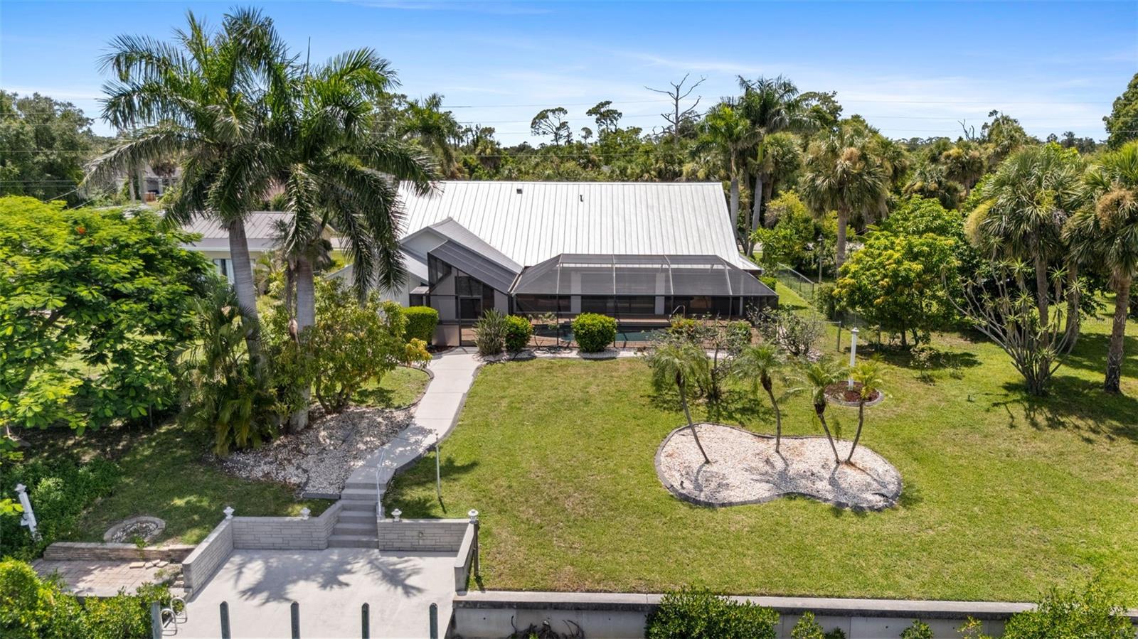 Waterfront Gulf Access home with a 20 minute boat ride in canal system to the open waters of paradise:) Location of the home is in an area of Port Charlotte surrounded by shopping and dining amenities. This 3 bedroom 2 bath home has 2598 square feet under air. High ceilings. Enjoy your brick paved pool deck with plenty of room to entertain. Spacious concrete dock. The mango tree produces delicious fruit. A/C is brand new/July 2025. Put your personal touches on this home and call it YOURS! The quaint downtowns of Englewood, Punta Gorda, and Venice are all within 25 minutes.