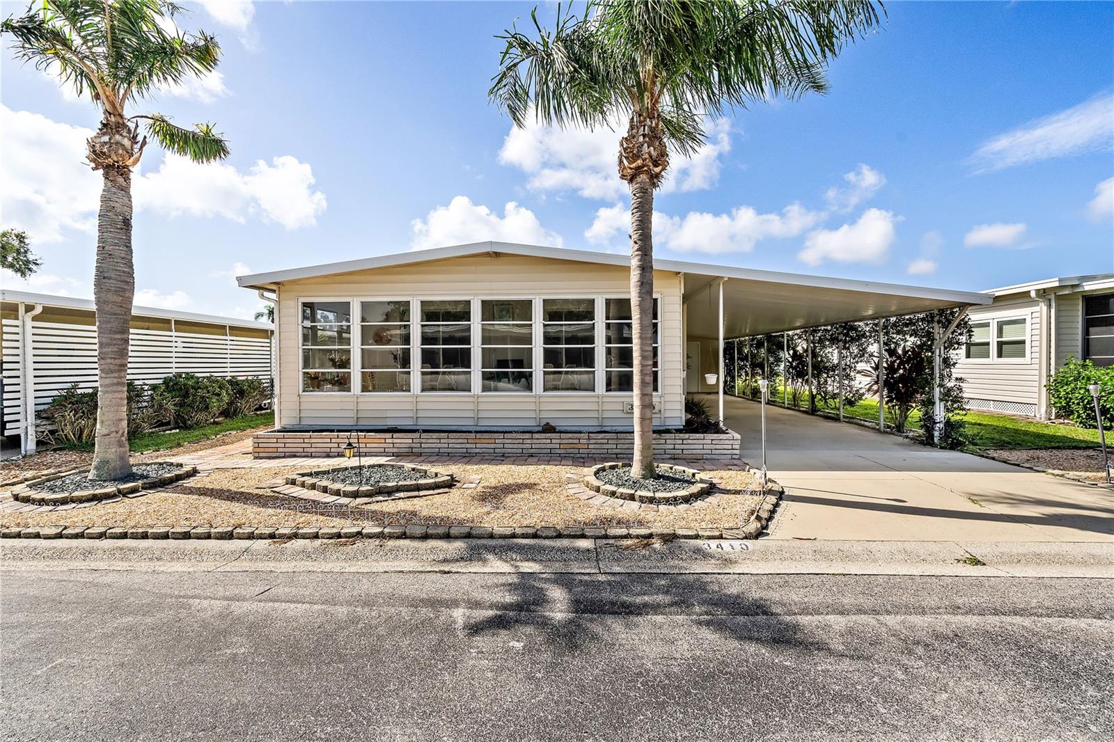 Welcome to this beautifully maintained 2-bedroom, 2-bath sanctuary—perfect for your second home or retirement dreams. Begin your mornings on the spacious enclosed front lanai, savoring your coffee and the serene surroundings. This charming home features an open floor plan with a bright and airy living room, ideal for entertaining guests or unwinding after a day of activities. The modern kitchen boasts ample counter space and a cozy breakfast nook, making meal prep a delight. The master bedroom offers a peaceful retreat with an en-suite bathroom and a walk-in closet, while the second bedroom is perfect for guests or a home office. You’ll appreciate the convenience of parking under the carport and a full-size laundry in the shed at the back of the carport. Nestled in the vibrant, gated 90-acre Oakwood Manor community—the only land-owned manufactured home community in the City of Sarasota—this home is a treasure trove of amenities designed to enrich your lifestyle. For a reasonable monthly fee of $190, enjoy a large clubhouse with a commercial kitchen, event stage, fitness room, cozy library, and more. Unwind in the heated pool with a handicap ramp, relax in the spacious hot tub, or partake in outdoor activities like bocce ball, ping pong, and picnicking under beautiful oak trees. This age-restricted social haven is conveniently located next to the scenic Legacy Trail and city pickleball courts. Just a short trip from downtown Sarasota, stylish St. Armands Circle, and the world-renowned Siesta Key Beach, this community offers the ultimate in Florida living. Live where others vacation and make every day a delightful adventure! Please note, no pets or motorcycles are allowed. Come embrace the fun, active lifestyle you’ve always dreamed of!