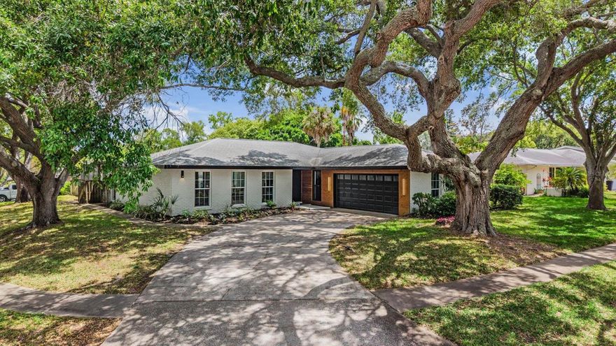 Welcome to this beautifully remodeled modern home with a seamless open-concept layout, where the living, dining, and kitchen areas flow effortlessly together. Features include wide-plank flooring, recessed lighting, skylights, and a striking wood beam that adds warmth and character.
The designer kitchen showcases custom cabinetry, porcelanite countertops, a spacious island with seating, and modern lighting, perfect for entertaining.
This home offers 4 bedrooms plus a versatile flex space, ideal for an office or gym. The laundry room includes a built-in desk and custom shelving, plus a central vacuum system for added convenience.
The primary suite features a spa-inspired bathroom with dual vanities, a soaking tub, and two walk-in showers.
Enjoy the covered back patio with wood ceilings, skylight, and ceiling fans, overlooking a screened-in pool, perfect for indoor-outdoor living.
Located in the highly desirable Westlake Village, with amenities including a park, tennis and pickleball courts, pool, and playground.
Not in a flood zone (FEMA) and approximately 40–50 feet above sea level, offering added peace of mind.