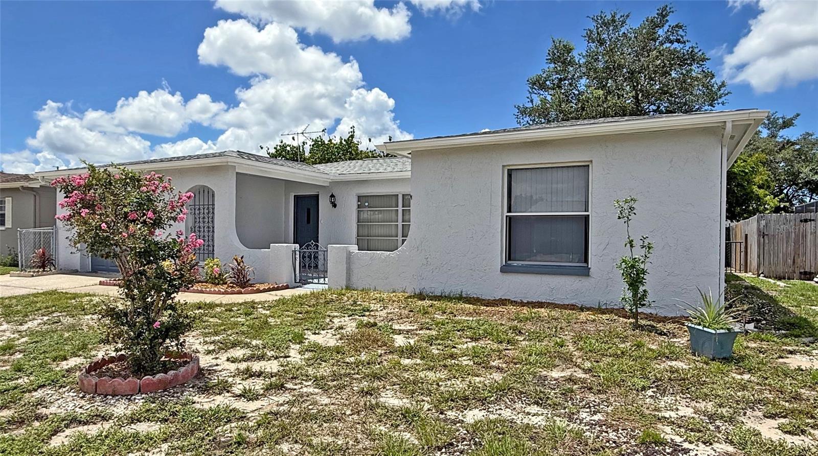 This charming 3-bedroom, 2-bath single-family home offers 1,442 square feet of comfortable living space in a quiet Port Richey neighborhood. Featuring a welcoming mix of tile and laminate flooring, central air conditioning, the home is designed for year-round comfort. The spacious layout includes an attached one-car garage for convenience and a manageable yard perfect for low-maintenance living. Recently renovated and ready for you. Located on a peaceful street, it provides easy access to local shopping, dining, and Gulf Coast attractions—making it an ideal place to call home.