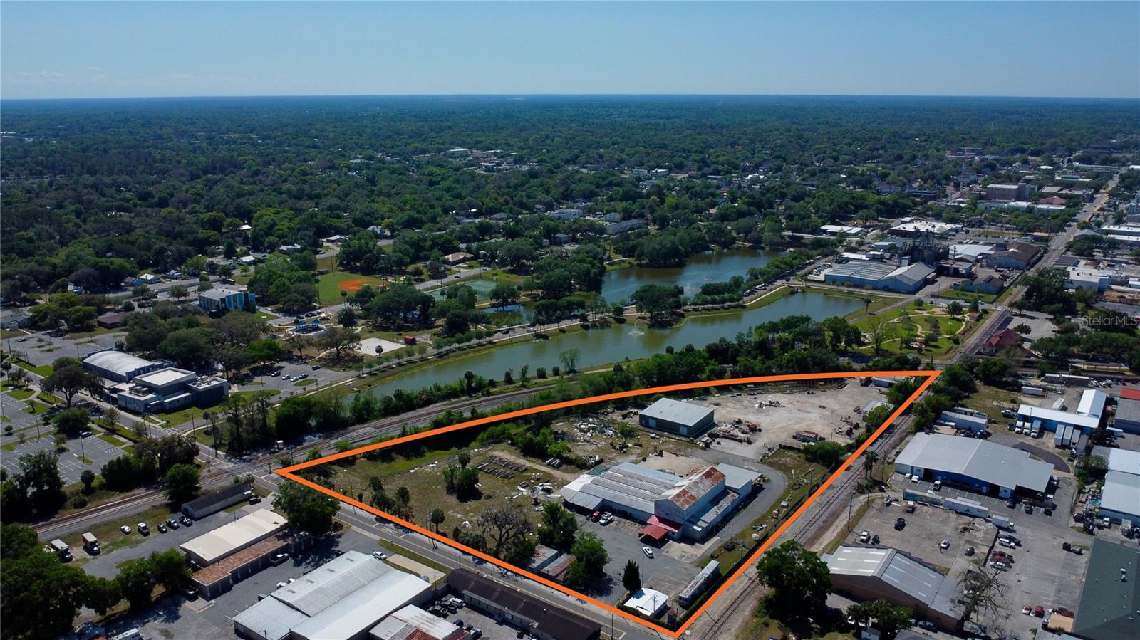 7.65 commercial acres located next to Ocala's beautiful Tuscawilla Park and the City's Performing Arts Theater. Seldom does a property of this size become available for purchase in the downtown Ocala area. Total tax and square footage has been calculated for both parcels and all buildings combined. The property features five buildings: 16,047sf warehouse (1945), 5,950sf warehouse (2013), 2,216sf warehouse (1959), 1,056sf office (1955) and a 600sf office (1945). The current zoning is M-2 (Medium Industrial) with Low Intensity Land Use. CSX rail borders the property's eastern boundary.
From the mid 1980's until several years ago, the property operated as "Svinga Brothers", a scrap-metal and recycling operation.
Current deed restrictions provide for industrial purposes only on the southern 3.12 acre parcel (26104-000-00). This entire parcel is sealed and covered with an 8" concrete pad as a result of the parcel's use from 1890's and 1950's as a manufactured gas plant, which deposited coal tar sludge into an onsite pit on the southern parcel. Environmental history and contacts are available.
The property is located within the City of Ocala's North Magnolia CRA (Community Redevelopment Area) and is eligible for significant tax incentive and improvement funds.
Highlights:
Five Buildings (25,869sf Total)
Historic Ocala 7.65 Commercial Acres
Overlooking Beautiful Tuscawilla Park and Performing Arts Theater
7.65 Acres
Industrial Zoning