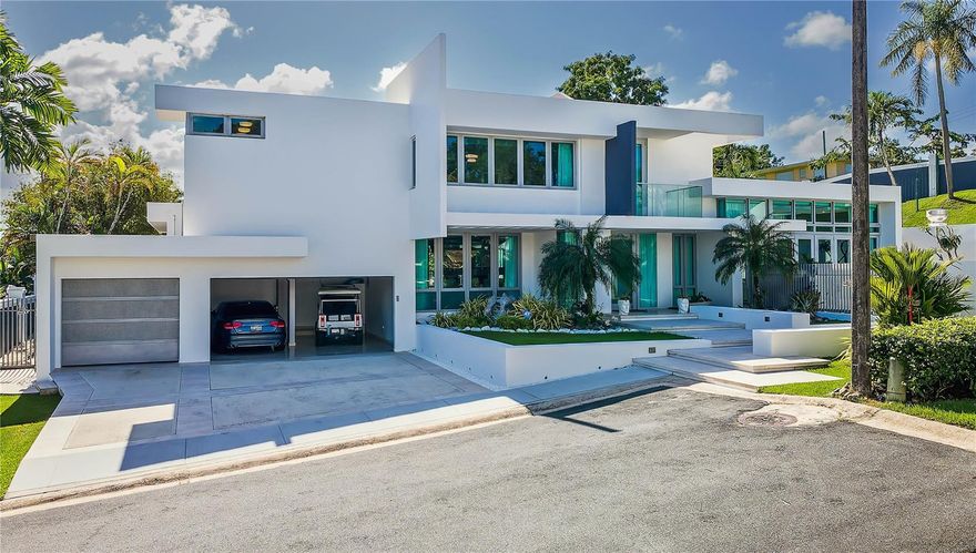 Located within the highly coveted enclave of Baldwin Park in Guaynabo, this stunning 2-level residence offers a modern aesthetic and expansive design situated on a 1,337.25 Sq. M. lot. Spanning a total of approx. 8,559 Sq. Ft., this home with 5 bedrooms and 6 bathrooms features a meticulously crafted open-concept layout that prioritizes seamless indoor-outdoor connectivity. The approx. 4,431 Sq. Ft. of air-conditioned space showcase light-filled living areas and marble flooring. Fully equipped for your culinary endeavors, the eat-in kitchen features a large center island and prime finishes. The second level houses 4 of the bedrooms and 3 of the bathrooms, in addition to a dedicated laundry area and tech-room. The primary suite is accented by a private exercise space with balcony, walk-in closet and spa-inspired bath with a jetted tub, double shower and dual vanities. Affording approx. 3,388 Sq. Ft. of alfresco space, the home’s exteriors serve as the ultimate sanctuary. The spacious covered patio with BBQ leads out to the heated salt-water pool, providing the perfect setting for relaxation or entertaining. A full-power generator, water cistern, detached utility room and 3-car garage with approx. 740 Sq. Ft. are some of the property’s additional highlights. A gated community in the suburbs, Baldwin Park offers ease and convenience within tranquil surroundings. Near some of Guaynabo's top destinations, such as the natural splendor of La Marquesa park and recreational facilities at Moises Garcia Navedo Sports Complex. Also a short drive away from Baldwin School and San Patricio Plaza, as well as a variety of other entertainment and shopping options.