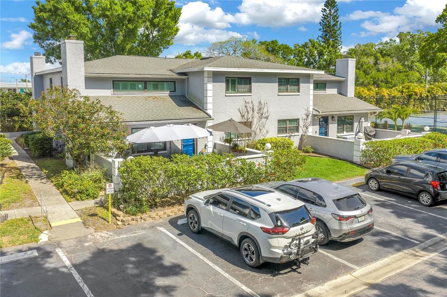 Tucked away in a quiet and highly desirable corner of St. Petersburg, this townhome style 2 story residence in Calais Village offers a rare blend of privacy, charm, and effortless Florida living. Perfectly positioned at the back of the building, this unique unit enjoys a secluded setting with its own private courtyard entry—creating an inviting, almost single-family home feel. Surrounded by lush, tropical landscaping, the home feels like a hidden retreat, where greenery and natural beauty provide exceptional privacy. The courtyard entrance sets the tone, offering a warm welcome and a peaceful space to relax or entertain, all while being shielded from the activity of the community. Inside, the home continues to impress with its comfortable layout and easy flow, ideal for both everyday living and hosting guests. Large HURRICANE IMPACT windows and thoughtful positioning allow natural light to filter in while maintaining the sense of seclusion that makes this unit so special. Inside, soaring ceilings elevate the main living area, highlighted by a cozy wood-burning fireplace and an open pass-through to the updated kitchen—perfect for both everyday living and entertaining. The kitchen is thoughtfully designed with leathered granite countertops, modern cabinetry, a closet pantry, and a convection oven, blending style with functionality. The versatile floor plan features two bedrooms with walk-in closets and two full baths thoughtfully positioned across two levels, offering flexibility and privacy. An upstairs loft provides additional living space—ideal for a home office, media room, or guest retreat. Indoor laundry and abundant interior storage add to the home’s convenience. Just outside, assigned parking space and additional guest parking, with the added benefit of being only steps from the community pool, basketball, and tennis & pickleball courts. Calais Village is known for its well-maintained grounds and convenient location, placing you just minutes from Sawgrass Lake park, shopping, dining, and the vibrant downtown St Pete waterfront. For buyers seeking something beyond the ordinary—a private oasis within a centrally located community—this exceptional property delivers both lifestyle and value. Monthly HOA fee covers everything except your electric bill - for $571.92 the fee covers upgraded cable, internet, water, trash removal, sewer, exterior maintenance (roof & paint) & grounds maintenance. Located in a no flood (X zone) this building is solid block construction.