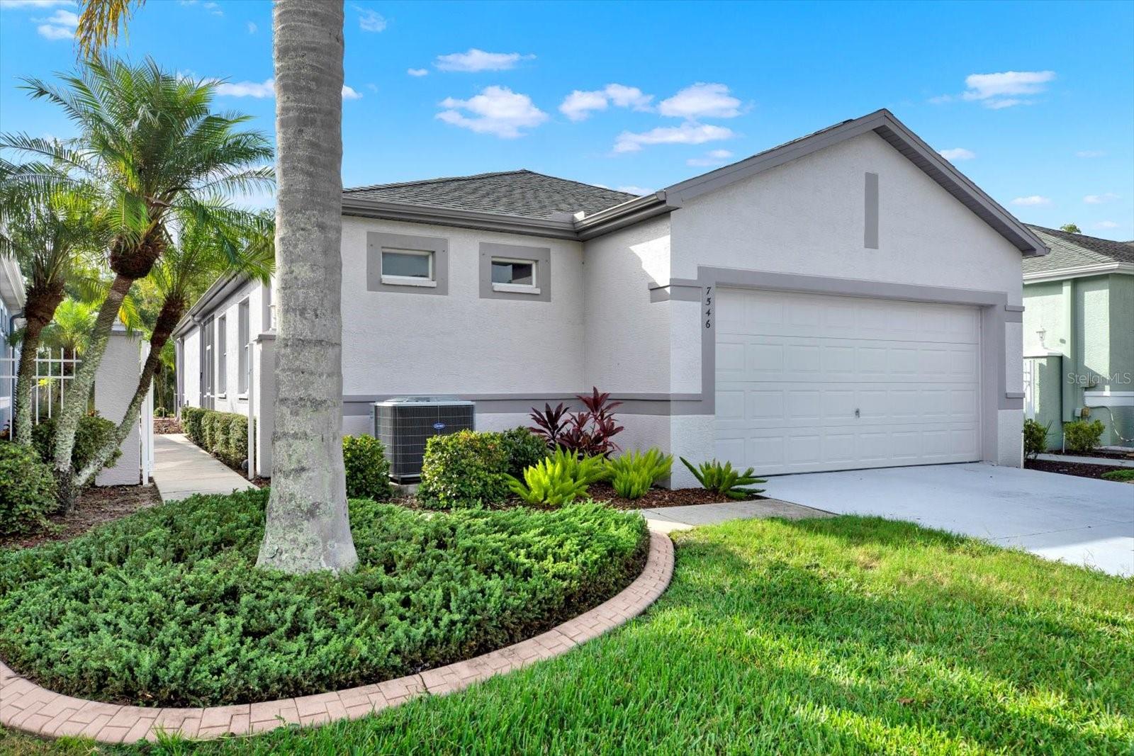 Welcome to The Groves Golf & Country Club, a premier active adult community in Land O’ Lakes! This charming 2 bedroom, 2 bathroom courtyard home offers comfort, convenience, and a beautiful setting. Step inside to a freshly painted interior (2025) with a split bedroom, open-concept floorplan—perfect for both entertaining AND privacy. The kitchen is equipped with all appliances plus a reverse osmosis water treatment system, and the home features a newer roof (2019) and a 1-year-old water softener for peace of mind. The laundry room includes the washer/dryer set that will remain with the home and the garage offers an extra ½ car of storage space for tools, boxes or your Golf Car Storage! Inside the 2 bedrooms include their own en suite bathrooms - so that you and your family/guests can enjoy time with each other AND some privacy at the same time. The extended covered and screened lanai overlooks a serene pond and conservation, creating the perfect backdrop for your morning coffee or evening retreat. And yes—the golf cart can be included with the sale!
Living in a courtyard home here means your exterior maintenance—roof, lawn, exterior paint, cable, and internet—is included in your quarterly dues, leaving you more time to enjoy the community amenities. At The Groves, every day feels like vacation with an 18-hole golf course, tennis courts, bocce ball, shuffleboard, fitness center, resort-style pool, dog park, and a vibrant clubhouse full of activities.
This home is move-in ready and waiting for its next owner to enjoy the lifestyle The Groves is known for!