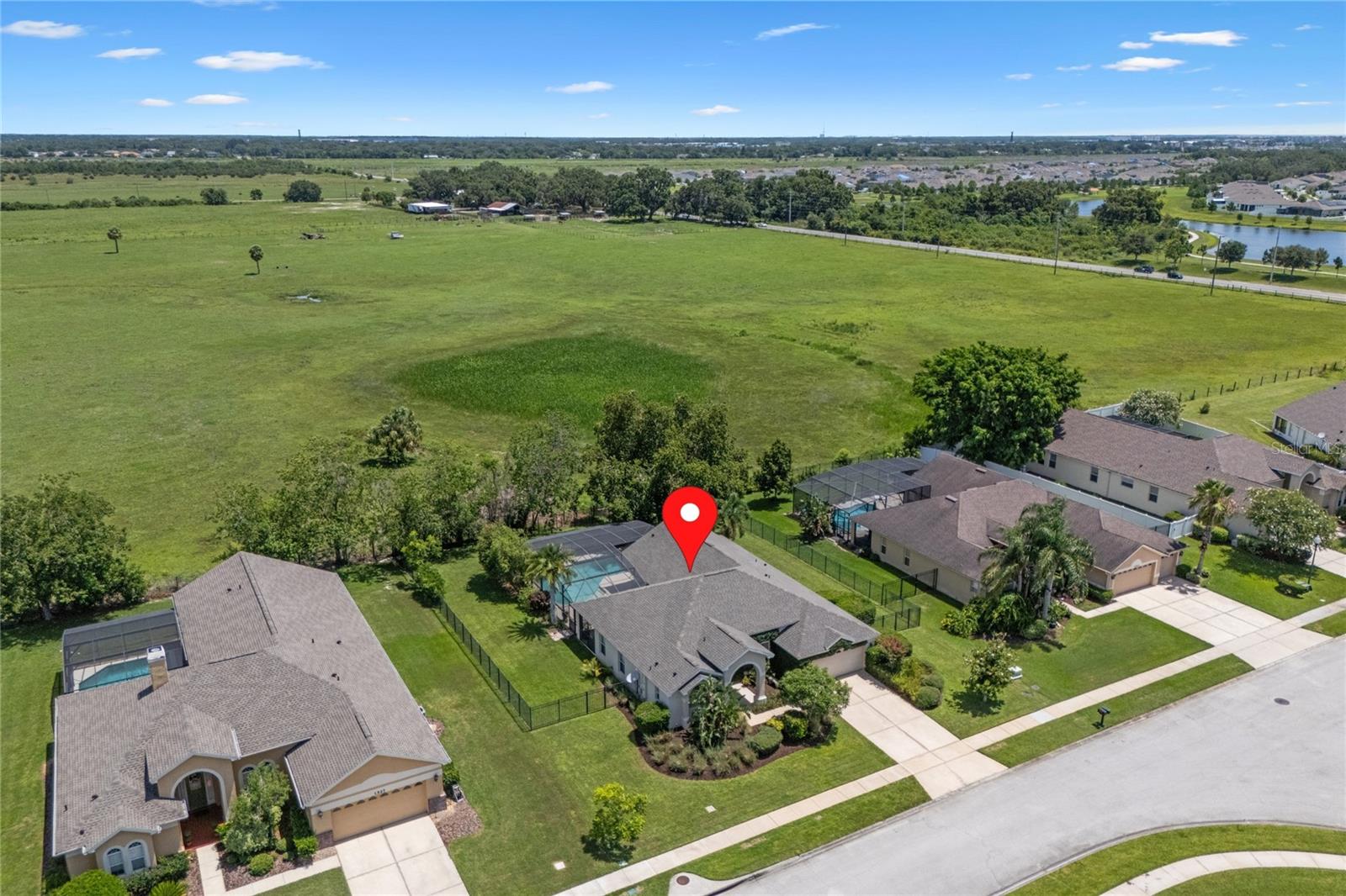A rare find in Kissimmee—this beautiful 4-bedroom, 3-bathroom pool home sits on an impressive 1/3 acre lot in the gated community of Ashley Cove, offering space, privacy, and functionality in one exceptional package. Backing onto mature trees with no rear neighbors, the fully fenced backyard provides a serene, private escape that’s perfect for both entertaining and everyday living.
Step through the covered front entryway and into a thoughtfully designed split-bedroom layout. The primary suite is located in its own wing, complete with French doors leading to the pool deck, two walk-in closets, and a spacious ensuite featuring both a soaking tub and separate shower, a private water closet, and dual vanities. On the opposite side of the home, the three secondary bedrooms are positioned around two full bathrooms—including a dedicated pool bath for convenient outdoor access.
The heart of the home features multiple living areas, decorative plant shelves, and a central kitchen with sleek countertops, modern cabinetry, and a layout that flows easily into the formal dining space and beyond. The adjacent laundry room includes built-in cabinetry for added storage and convenience. Throughout the home, thoughtful design details and a well-balanced layout create a space that feels both stylish and practical.
Step outside to the screened-in pool and prepare to be wowed by the huge pool! The covered lanai offers the perfect spot to relax in the shade, while the oversized backyard invites everything from peaceful mornings to lively weekend gatherings. Plus, the practical bronze cage is designed for low maintenance.
All of this is set just 5 minutes from Florida’s Turnpike, 25 minutes to Orlando International Airport, and 35 minutes to Walt Disney World, combining the benefits of space and quiet with exceptional accessibility. Roof replaced in 2023.