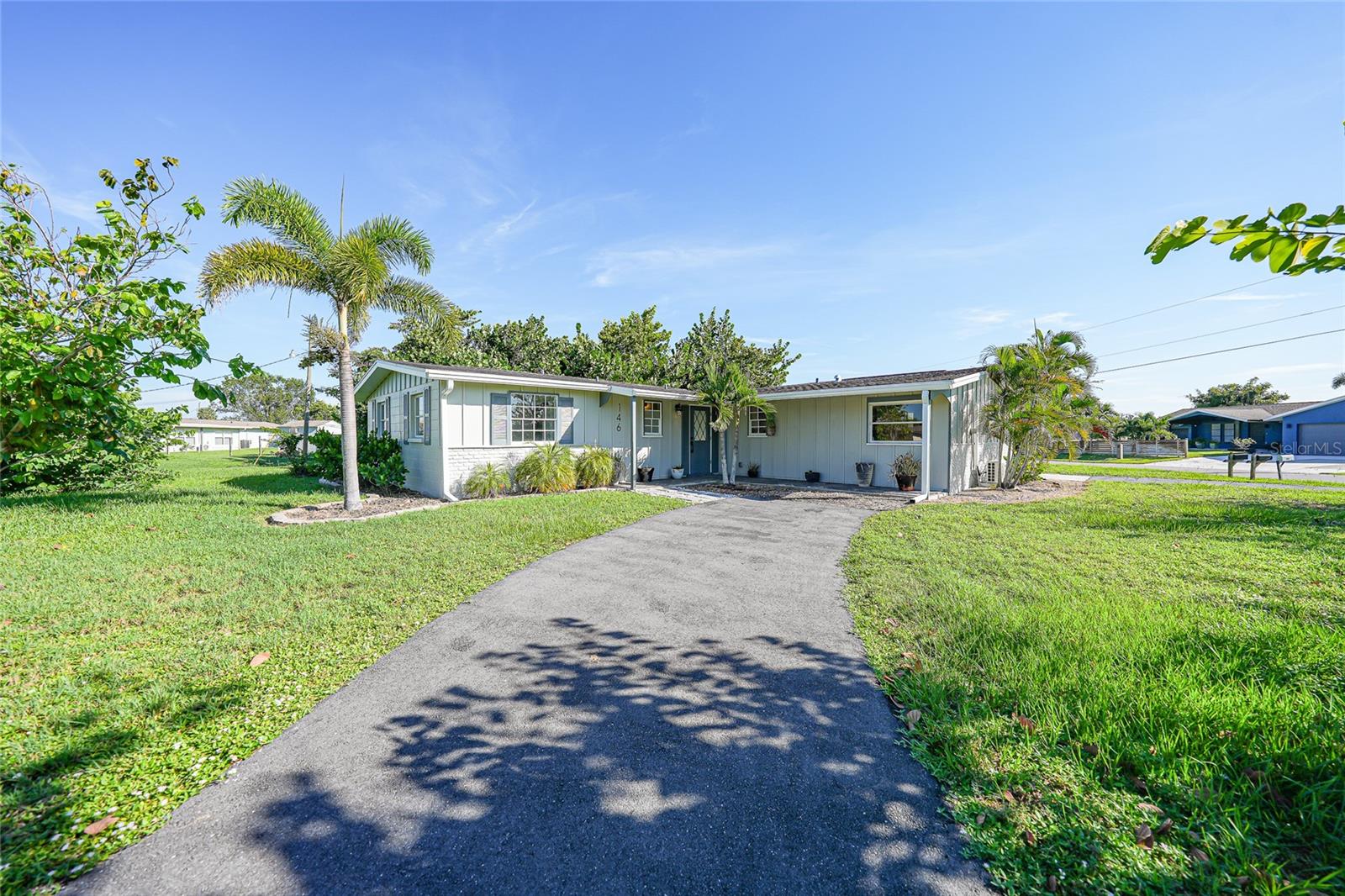 One or more photo(s) has been virtually staged. Don’t miss the opportunity to own this fully remodeled 3-bedroom, 2-bathroom home in the heart of Port Charlotte! Completely updated in 2025, including new electrical work, fresh interior paint, modern tile flooring, and stylish finishes, this home blends contemporary comfort with thoughtful design throughout its 1,709 square feet of living space. Set on an oversized lot, the property welcomes you with two paved driveways, covered parking, mature trees, and tasteful landscaping that enhance its inviting curb appeal. Inside, a bright and spacious living room flows seamlessly into the sun-drenched Florida room, complete with A/C, where walls of windows frame serene outdoor views. The updated kitchen impresses with crisp white cabinetry, sleek hardware, and Quartz countertops that combine style and durability. Neutral tile flooring and soft wall colors create a warm, inviting space, while a stainless-steel double sink, built-in microwave, and dishwasher add convenience. A stainless-steel stove and refrigerator will be added soon, completing this modern and functional kitchen. With ample counter space and generous cabinet storage, the layout is ready for your personal touch. The primary bedroom offers a spacious walk-in closet and an en-suite bath with a walk-in shower, frameless glass enclosure, and luxurious rainfall showerhead. Two additional bedrooms, each with built-in closets, provide flexible space for family, guests, or a home office, and share an updated full bath with modern finishes. Step outside to your private backyard oasis, where lush landscaping creates a peaceful retreat perfect for relaxing or entertaining. Roof installed in 2017 and A/C system replaced in 2008. A built-in shed provides convenient storage for tools, equipment, or seasonal items. Nestled in an established neighborhood, this home is just minutes from Port Charlotte Beach Park, offering a public beach, boat ramp, picnic areas, tennis courts, and more. Enjoy easy access to US-41, I-75, shopping, dining, hospitals, and some of the area’s top-rated parks and beaches. *PLEASE ENJOY THE 3D INTERACTIVE VIRTUAL TOUR ASSOCIATED WITH THIS LISTING**