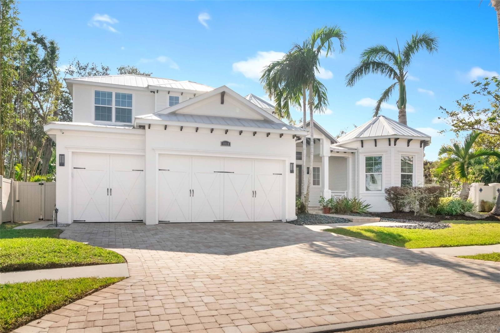 Nestled in the highly sought-after West of Trail neighborhood, this exquisite Allegra custom home, formerly the 2015 model, offers an unparalleled living experience. A true showcase of craftsmanship, the residence features custom millwork, striking feature walls, and intricate ceiling details that elevate every space. Upon entering, you are welcomed by soaring 20-foot beamed ceilings, a windowed rotunda, and an expansive, sun-drenched open-concept floor plan. Oversized 10-foot sliding glass doors effortlessly blend the indoors with the resort-style outdoor oasis. Spanning 3,582 square feet, this home boasts four spacious bedrooms, three luxurious bathrooms, a versatile bonus room, and a dedicated office, making it ideal for today’s dynamic lifestyle. Rich porcelain wood-style floors on the main level and engineered wood floors upstairs bring warmth and sophistication to every room. The gourmet kitchen is a culinary masterpiece, featuring top-tier Sub-Zero and Wolf appliances, including a five-burner gas cooktop with pot filler, full-size wine refrigerator, double wall ovens, under-counter microwave, and stunning granite countertops with a glass-tiled backsplash. Adjacent to the kitchen, the dining room overlooks the outdoor sanctuary and includes a built-in buffet with a mirrored feature wall. Double doors lead into the spacious bonus room, complete with a wet bar and built-in entertainment center. A disappearing corner of sliding doors opens to the covered lanai, where you will find an outdoor kitchen perfect for al fresco dining. The primary suite is a standout feature of the home, with a wall of windows and impressive ceiling details enhanced by uplighting. The serene retreat includes a spa-like bath with a walk-through shower and outdoor shower, offering ultimate privacy and relaxation. The custom-designed walk-in closet, complete with built-in shelving, drawers, and a hallway dressing mirror, adds an extra layer of luxury. The adjacent office, also with custom built-ins and thoughtful ceiling details, completes this extraordinary suite. On the first floor, an additional generously sized bedroom offers convenience and comfort, while two more bedrooms upstairs provide ample space for family or guests. The home’s thoughtful design ensures a seamless flow between spaces, with abundant natural light illuminating every room. The outdoor living area is just as impressive, featuring a heated saltwater pool and spa, rainfall pergola, natural gas firepit, and a covered outdoor kitchen and dining area—perfect for both peaceful evenings and lively gatherings. Set on a lush .26-acre lot in one of Sarasota’s most desirable neighborhoods, this home combines luxury with convenience. Just minutes from Southside Village, Sarasota Memorial Hospital, and top-rated Southside Elementary School, 1810 Wisteria Street offers an unparalleled opportunity to enjoy the best of Sarasota living.