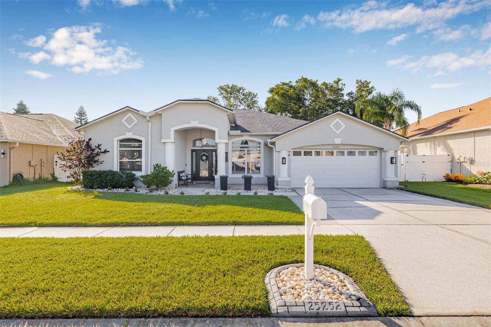 Experience Luxury Florida living in this fully renovated, SMART-enabled POOL home offering comfort and high-end design throughout. Located on a peaceful lot with serene pond views, this 4-bedroom, 3-bath home combines modern innovation with warm, inviting style, offering a turnkey lifestyle in one of Land O’ Lakes' most affordable HOA communities!
Inside, you’ll be welcomed by continuous 6”x24” wood-look porcelain tile flooring and soaring 10-foot ceilings, and a BONUS space that would be great as an office! Entertain with ease with a walk in pantry, oversized island, built-in storage, and custom cabinetry including 40” tall, 15” deep uppers with crown molding, and modern hardware. A 36” cooktop is paired with a commercial-style externally vented hood, while the double ovens, granite countertops, marble backsplash, under-cabinet lighting, and dimmable smart light controls.
The primary suite is a true retreat, tucked away for privacy and generously sized. You'll find expanded dual walk-in closets, a peaceful private work out room or office with a custom barn doors. The ensuite bathroom features custom design choices, including a stand alone tub, level entry shower, curated lighting, and premium finishes.
The two renovated guest bathrooms add thoughtful upgrades to daily living. The cabana bath includes a new exterior door with built-in blinds, a custom vanity with designer lighting, shiplap accents, and floor-to-ceiling 12"x24" tiled shower enclosure. The hallway bath includes a full double-sink vanity with new cabinetry, updated fixtures, designer mirrors, floor-to-ceiling tile in the tub/shower, and beautiful color-matched shelving.
Step outside to your own backyard escape! The heated saltwater pool and spa are surrounded by a new paver deck, screen enclosure, and beautifully maintained landscaping — all oriented toward peaceful pond views. Whether you're hosting summer pool parties, enjoying a quiet evening soak under the stars, or working remotely poolside, this outdoor space is an absolute highlight of the property.
The home also features a Tesla Home Connector EV charger on a dedicated 60A circuit, a Rheem hybrid SMART water heater (2021), and an EcoWater SMART water softener system (2021). Additional SMART features include a Ring Alarm system and video doorbell, Arlo cameras, Nest Protect smoke/CO detectors (hardwired with backup), Ecobee SMART thermostat, Lutron Caseta SMART lighting controls, smart locks, and SMART garage controls. Even the exterior holiday lights are automated, with Govee permanent LED lighting. The roof was replaced in 2020 with architectural shingles rated for 50 years too!
This home is located in a peaceful, amenity-rich community with one of the lowest HOA fees in the area, yet offers resort-style amenities including a community pool, clubhouse, fitness center, basketball and volleyball courts, and shaded walking trails under majestic oak trees.
It's just minutes from the Tampa Premium Outlets, The Grove, The Krates, movie theaters, golf courses, highly rated schools, top medical facilities, and tons of dining and shopping options. Plus, you’re close to I-75/I-275 with quick access to Tampa, Lakeland, and even Orlando, without the long, congested drives similar in other neighborhoods.
This home checks every box: luxury upgrades, cutting-edge technology, private pool/spa, tranquil pond views, amazing layout, low HOA, and serious pride of ownership! Schedule a showing today!