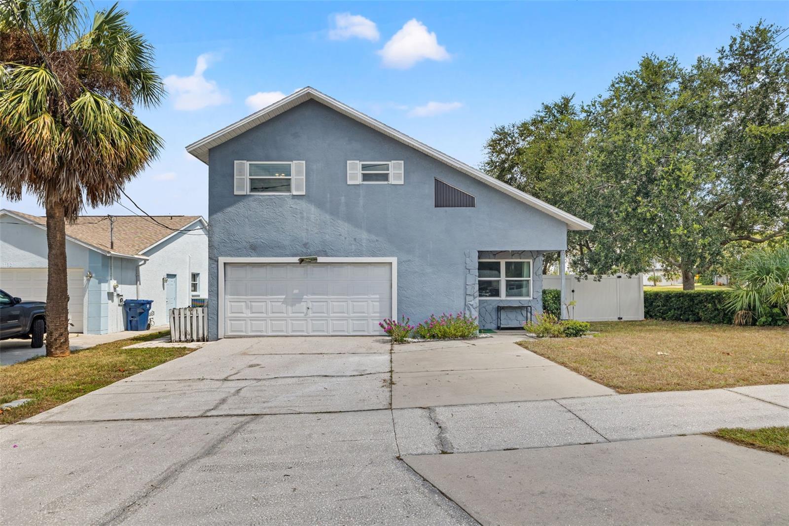This home is located in the desirable Oakhurst Shores neighborhood in Seminole. This home has been in the same family for over 40 years and has been lovingly cared for and maintained. The allure of this home and location is hard to beat, with it being just a five-minute drive to the Gulf. Madeira Beach has miles of beautiful coastline, plenty of entertainment, and the quintessential Johns Pass Village and Boardwalk. Additionally, this home is located in an X-flood zone (no flood insurance required), evacuation zone 'E', and it is over 23 feet above sea level. This custom home has beautiful cathedral ceilings in the living room that make the space feel welcoming and expansive. The kitchen features wood cabinets, stainless steel appliances, and bar seating. Just off the kitchen is the formal dining space with a working wood-burning fireplace. Off the back of the home is a generously-sized family room that could also be a great bonus office space/flex room. The backyard is the perfect blend of welcoming and low-maintenance. There is a large enclosed porch with vaulted ceilings that looks out over the xeroscape backyard. There is a brick paver patio leading to an outdoor dining area, astroturf throughout, newer white vinyl fencing, and off the side yard is space to park a boat/RV. Heading upstairs, you will find all three bedrooms. The primary bedroom has a walk-in closet, brand-new shower, and an oversized vanity. On the other side of the bedroom is an additional bonus storage area that could double as a second closet, or it would also be a great office space. Down the hallway are the other two guest rooms and the guest bathroom. The A/C system was replaced in 2022, almost all of the windows are impact-rated, interior doors were replaced in 2021, newer stainless steel appliances were installed, and the washer and dryer stay with the home. This home has so much to offer!