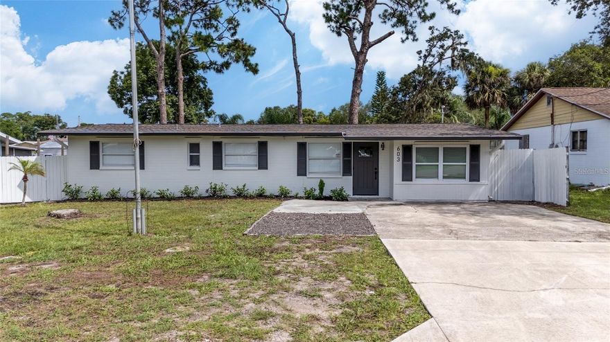 One or more photo(s) has been virtually staged. Welcome to your newly renovated 3-bedroom, 2-bathroom home with an additional flex room just 11 minutes from the beautiful sands of New Smyrna Beach! This home has been thoughtfully updated with modern finishes and upgrades throughout, offering both comfort and style. Inside, enjoy new vinyl plank flooring, fresh interior and exterior paint, and an updated kitchen featuring brand-new stainless steel appliances, countertops, and cabinets. Both bathrooms have been fully updated with new vanities, shower tiles, faucets, lighting, and hardware for a sleek, contemporary look. Major updates include a recently updated roof, AC, water heater, and gutters, ensuring peace of mind for years to come. Step outside to a fully fenced backyard, complete with a covered wood deck and fire pit, perfect for relaxing evenings or entertaining guests. You'll also enjoy an oversized driveway, great for extra parking! With no HOA and located outside of a flood zone, this property offers full freedom to customize as you see fit and low-maintenance living. Conveniently located near shopping, dining, and Florida’s stunning coastline, this home is move-in ready. Schedule your showing today!