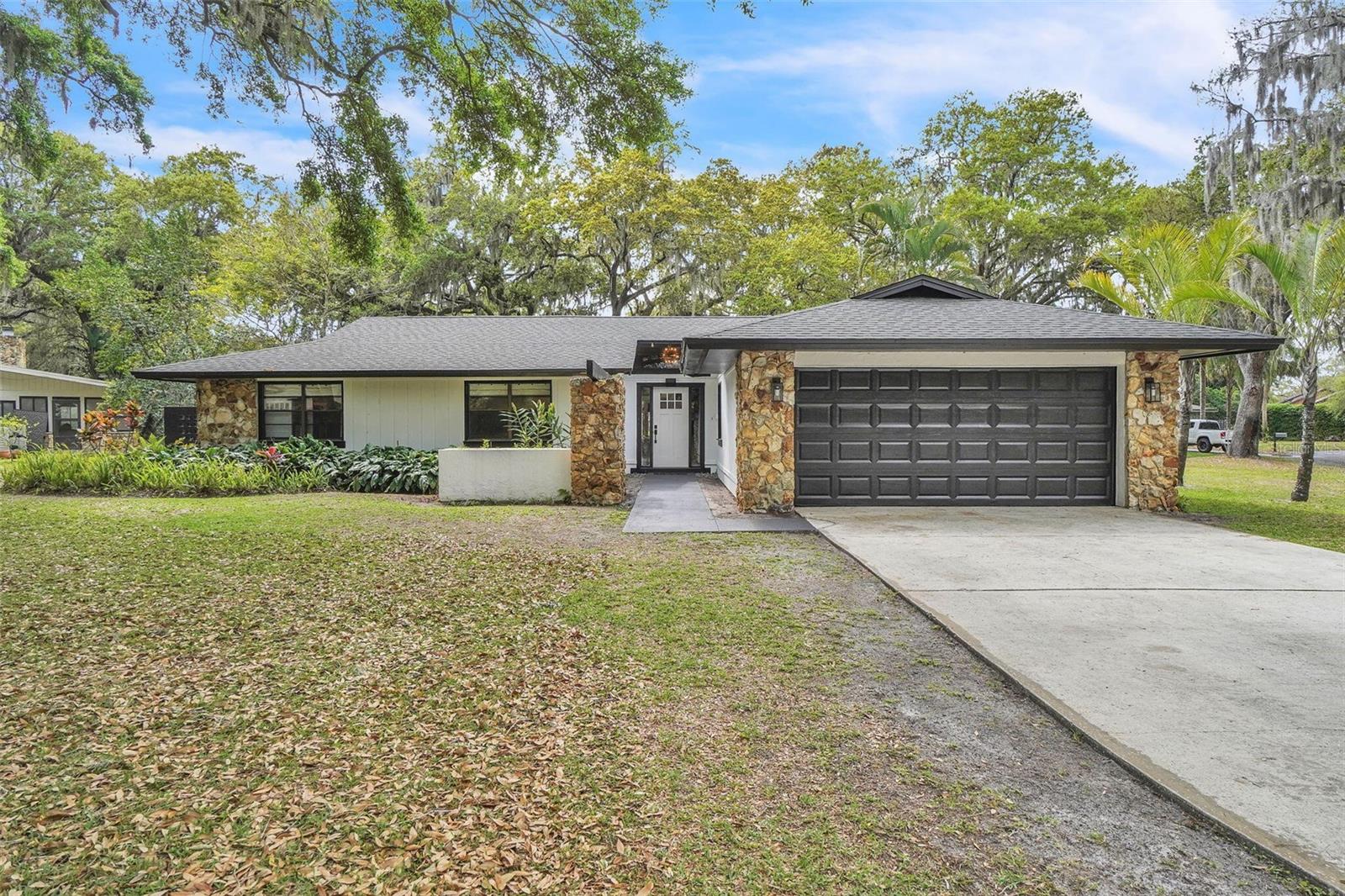 Completely Remodeled! Water access to Lake Toho! Mid-Century Modern Retreat with Private Lake Access Minutes from Lake Nona, Lower Taxes in Osceola County! Experience the perfect blend of modern luxury and functional design in this stunning 3 bedroom, 2 full-bath home, fully remodeled with a sleek mid-century modern aesthetic. Situated on over half an acre, this property offers private boat access to East Lake Toho, Fells Cove, and Ajay Lake, making it a dream for water enthusiasts. Step inside to an expansive, open concept living area highlighted by vaulted ceilings, abundant natural light, and high-end laminate flooring throughout. The chef’s kitchen is a showstopper, featuring Cafe smart appliances controllable via mobile app, an induction cooktop, custom matte-bla cabinets, and a massive waterfall island that comfortably seats eight. A formal dining room and additional breakfast nook provide versatile space for entertaining family and friends. The master suite is a private retreat, complete with a spa-like bathroom that includes a Japanese soaking tub, dual rainfall shower heads, and direct access to a serene courtyard, relaxing mornings or evening unwinding. Two additional spacious bedrooms share a fully updated bath, providing comfort and style for family or guests. Additional highlights include: • Paid-off solar system for energy efficiency and long-term savings • New A/C installed in 2020 • Laundry room with convenient drop zone •. Expansive yard offering endless possibilities for outdoor living, gardening, or entertaining Prime Location: Enjoy proximity to the highly desirable Lake Nona area, including Medical City, shopping, dining, and entertainment, while benefiting from lower property taxes in Osceola County. This is a rare opportunity to live close to the energy and amenities of Lake Nona without the higher tax burden. This home is a true combination of designer style, modern efficiency, and an unbeatable location. Whether you’re hosting gatherings in the chef’s kitchen, relaxing in the master courtyard, or boating on nearby lakes, this property is designed for living your best Florida lifestyle. Don’t miss the chance to own a one-of-a-kind home that delivers luxury, convenience, and value all in one exceptional package.