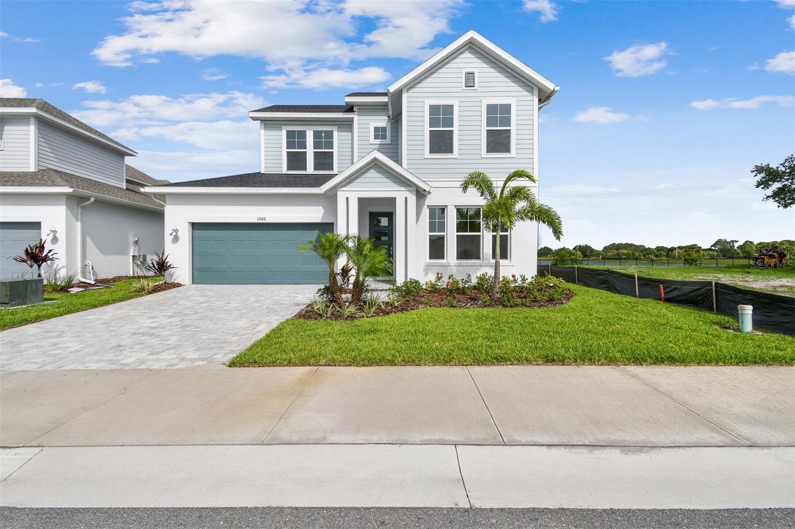 Designer Style Meets Function in This Stunning Seamount Plan on Spoon Bill Lake! Step into effortless luxury in this thoughtfully designed two-story Seamount floor plan, perfectly positioned on a desirable waterview homesite in Emerald Landing at Waterside—just 5 minutes from vibrant Waterside and a short 15-minute stroll to the heart of the action. From the moment you walk in, this home makes an impression. A private study just off the entry offers the perfect work-from-home space, while the 3-car garage leads into a highly functional mudroom-style drop zone featuring a backpack rack, shoe cubbies, and a spacious laundry room with folding counter—built for real life. The heart of the home is a designer chef’s kitchen where elegance meets performance: quartz countertops, luxury finishes, a gas cooktop, built-in oven and microwave, wine fridge, and statement designer range hood, anchored by an expansive open-concept layout connecting the kitchen, family room, and dining space. Soft-close cabinetry and a walk-in pantry you could get lost in, complete the dream kitchen setup. A sliding glass door opens to your covered lanai, perfect for seamless indoor-outdoor living. Your primary suite is conveniently located downstairs, showcasing laminate flooring throughout the first floor, a spa-inspired ensuite with a freestanding soaking tub, walk-in shower, and a generously sized walk-in closet. Upstairs, you’ll find three additional bedrooms, two full baths, a balcony facing the lake, and a flexible retreat room—ideal as a second office, game room, or even a golf simulator setup. Enjoy energy-efficient living with a tankless water heater, and high-end touches throughout like HURRICANE IMPACT windows. Located in one of the most desirable new communities, you'll love being just minutes from Waterside’s shops, dining, and entertainment. The amenity center at Emerald landing offers a heated lap pool, pickle ball courts, dog park, clubhouse and fire pit. Homesite and is Ready NOW! This property offers exceptional quality, energy efficiency, and peace of mind with a comprehensive 1, 2, 10-year warranty. Reach out to our sales team today for more details and to make this your dream home!