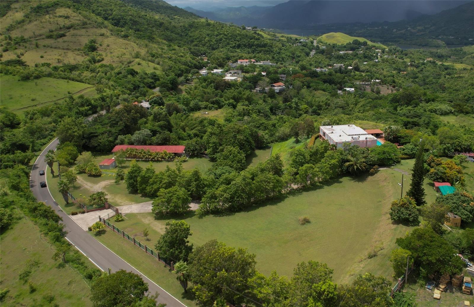 SELLER FINANCING AVAILABLE – ACT 60 TOURISM INCENTIVES OPPORTUNITY
Just 1 hour and 15 minutes from San Juan.
Hacienda Don Pedro Refined Caribbean Ranch Meets Classic Puerto Rican Hacienda
An Estate Rooted in Heritage, Designed for Lifestyle
Step into a property where heritage, design, and natural beauty come together in perfect harmony. This extraordinary Puerto Rican hacienda captures the essence of a colonial ranch-style estate, elevated with tropical countryside charm and designed for those who appreciate authenticity, space, and lifestyle.
?? Hacienda-Style Highlights
Colonial Hacienda Layout
The heart of the home is a traditional layout inspired by Spanish colonial estates—featuring a spacious central living room, soaring double-height ceilings, gallery-style balconies, and an elegant flow that brings light and warmth throughout.
Rustic and Equestrian Influences
A covered stable and gathering area reflects the property's equestrian soul. Terracotta tones, wrought iron accents, and saddle décor blend rustic function with refined charm, offering the perfect space for both horse lovers and event hosts.
Expansive Grounds with Natural Flow
The aerial perspective reveals manicured landscapes, a tree-lined private driveway, open green pastures, and carefully placed structures. The gently sloping terrain embraces the hacienda, ideal for agricultural ventures, a boutique guesthouse, or a serene private retreat.
Traditional Materials
The estate is grounded in timeless design—terracotta tile floors, solid wood finishes, hand-forged ironwork, and sturdy columns speak to Caribbean craftsmanship and enduring quality.
Indoor-Outdoor Living
Enjoy effortless flow from indoor spaces to open-air patios, a swimming pool surrounded by greenery, and shaded gathering spots. The home is made for entertaining, relaxing, and celebrating Puerto Rico’s year-round beauty.
Authentic Interior Touches
Rich textures, vibrant color palettes, handcrafted details, and curated artwork celebrate Puerto Rican culture and lend every space a sense of soul and story.
________________________________________
This is more than a property—it’s a lifestyle sanctuary. Whether envisioned as an equestrian ranch, a boutique bed & breakfast, or a multigenerational compound, this estate invites you to live with purpose and beauty in the heart of Puerto Rico.