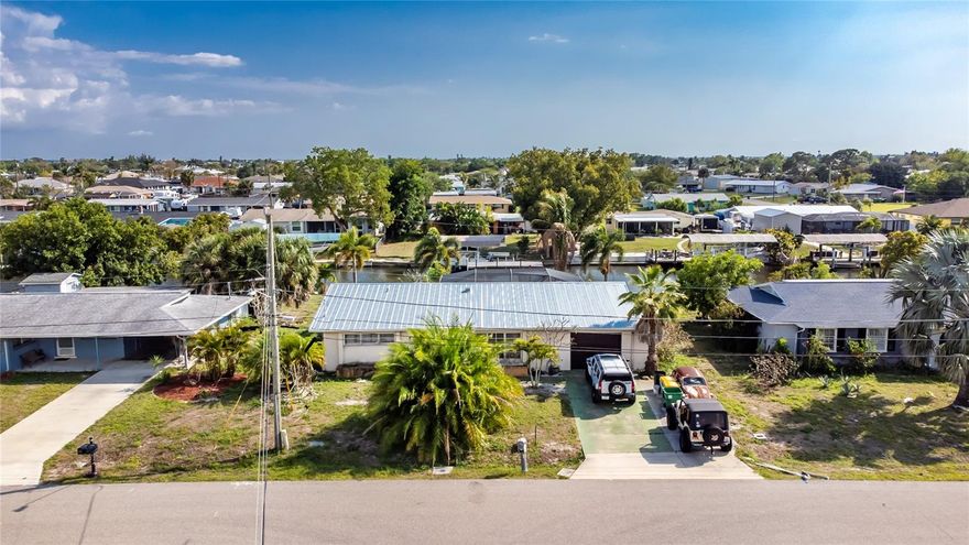 Don’t miss this 3-bedroom, 2-bath canal-front home in a sought-after Port Charlotte canal neighborhood. No HOA or rental restrictions! With many important updates already completed, this home is ready for you to enjoy the Florida lifestyle. Improvements include a saltwater pool added in 2010, new electric panel in 2019, new A/C in 2020, plus overhead flex piping and a new roof in 2025. Hurricane shutters provide added convenience and peace of mind.  The home offers comfortable living space, a huge walk-in closet in the primary suite, and a whole-house fan for added comfort. Relax by the pool or take in canal views from your backyard. All bedrooms are roomy enough for a king size bed. The property also features a dock and lift; however, the dock is not warranted and the lift is not currently working.  Conveniently located close to historic downtown Punta Gorda, shopping, dining, golf courses, and Southwest Florida’s famous beaches, this is your chance to own a slice of paradise.
