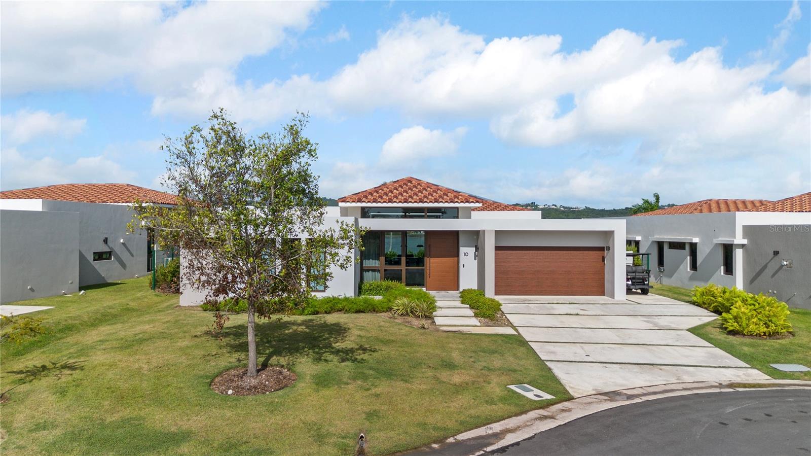 One or more photo(s) has been virtually staged. Location and front lake, golf view, overlooking El Yunque Rainforest are only one of the best characteristic of this modern one level home. In the heart of Palmas Del Mar Resort in Humacao, Puerto Rico, this spectacular, fully furnished and equipped NEW property, will satisfy all needs for a family looking for peace, elegance, luxury, comfort and more. Pictures don't do justice to the beautiful well maintained property, the landscaping, the amazing sunsets with pink skies, the modern kitchen with open concepts, the covered high ceilings terrace, is just the beginning when you come tour this house. Each of the four bedrooms are beautifully decorated to the last detail. The Master Bathroom is unique, Master Bedroom Closet has enough space for his and hers, Kitchen appliances are Monogram, there is even a removable gym in the garage with a dedicated AC Unit. The house has generator, eight AC split units, solar water heater, 4 bedrooms, 3.5 bathrooms, dinning room, living room, family room, fully equipped kitchen and more. Los Lagos at Palmas is the only new construction development in Palmas Del Mar. Los Lagos Club House is located walking distance to this house and you can enjoy there a modern Fitness Center, Infinity Pool, Hot Aqua therapy pools, luxury event venue and mini golf. There is a second Club House under construction with 3 pickle ball courts, 24 parking spaces, kids playground and more. Palmas Del Mar Resort has a Beach Club, tennis center, fitness center, dog park, kids park, golf, hotels, many restaurants and more. Here you can find the Resort Lifestyle your family and you deserve. This property is available for showings now and ready to be delivered in Summer.