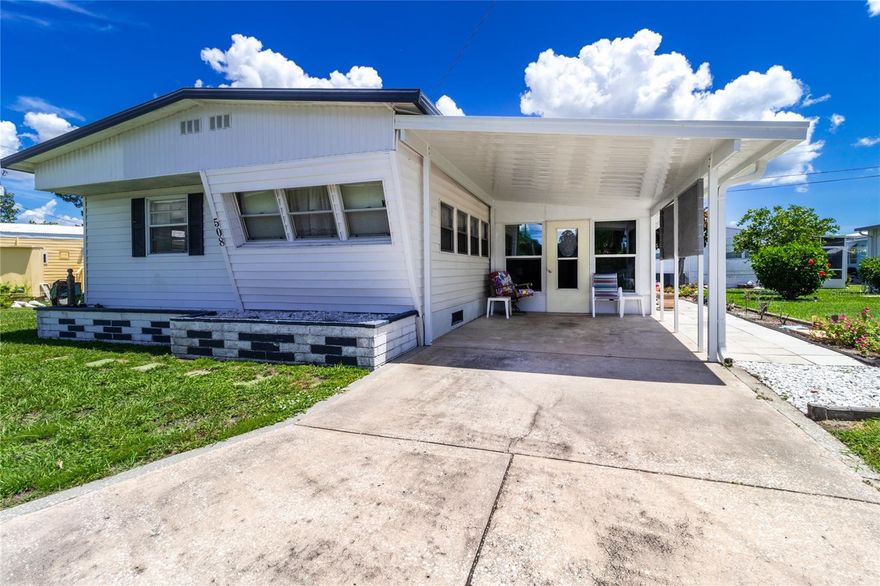 *Rare Non-Aged Restricted* Welcome to low-maintenance living with a splash of fun in Fair Lane Acres—a lively community where neighbors quickly become friends. This move-in ready 2-bedroom, 2-bathroom mobile home offers 1,022 square feet of inviting space designed for comfort and connection. Step into a large living room with newer carpet and plenty of room to host or simply kick back and relax. The dining area seamlessly connects for easy entertaining. The primary bedroom features newer carpet and a generous walk-in closet. A second bedroom offers flexibility for guests or creative pursuits. An enclosed porch off the carport provides even more space—ideal for morning coffee or mild-weather lounging. Practical perks include covered parking, a sizable storage shed with washer and dryer included, and a second bathroom for added convenience along with a second shed for lawn equipment and additional storage. Best of all, you’ll own the land—no lot fees to sneak up on you—and enjoy modest monthly dues that cover water, sewer, and access to an exciting lineup of community amenities. From the pool to the pickleball courts, shuffleboard games to lively dinners and dances, there's always something happening in Fair Lane Acres. But don’t worry—quiet moments with a good book, or impromptu porch chats with neighbors, are just as welcome. Conveniently located close to grocery stores, public transit, parks, and sunny Gulf beaches, you’re never far from what matters. Whether you're seeking connection, convenience, or charm—all roads lead here. Don’t miss your chance to join this vibrant community. Schedule your visit today!