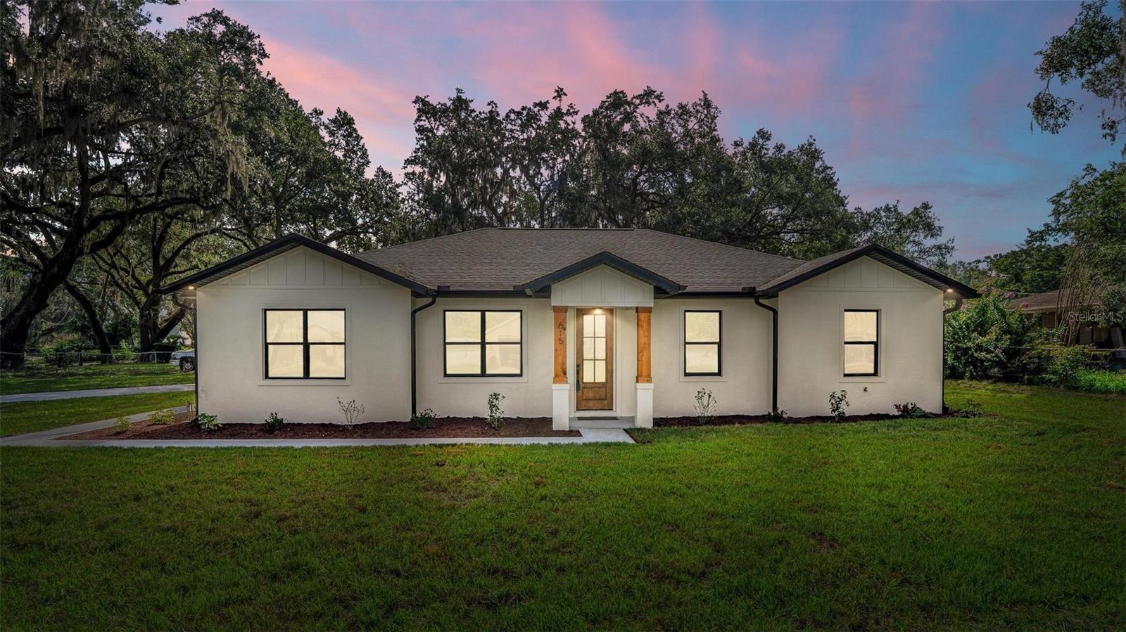 BRAND NEW MODERN HOME—NO HOA & ROOM FOR YOUR RV OR BOAT! Welcome to your stunning new-construction home, thoughtfully designed with contemporary style and luxurious finishes throughout. Situated on a spacious .44-acre lot shaded by gorgeous mature oak trees, this home offers 1,979 sq ft of elegant heated and cooled living space, with a total of 2,636 sq ft under roof. The open-concept floor plan showcases beautiful Luxury Vinyl Plank flooring, stylish quartz countertops, pristine 42-inch white shaker cabinets, and brand-new stainless steel appliances.
Relax in your serene primary suite, featuring a spa-like ensuite bath with a striking tile shower. Three additional generously sized bedrooms ensure ample space for family, guests, or a home office. The guest bath includes a beautifully tiled tub surround, complementing the home's upscale design. Enjoy the convenience of an interior laundry room, perfectly located for easy access.
Entertain or unwind outdoors on the covered 173 sq ft lanai overlooking your spacious, shaded backyard—perfect for gatherings or quiet mornings. A side-entry 2-car garage (448 sq ft) provides ample parking and storage.
Enjoy the freedom of NO HOA—park your boat, RV, or additional vehicles right at home. Don’t miss this opportunity to own a beautiful new construction home designed for modern living, with space and flexibility to fit your lifestyle. Schedule your showing today!