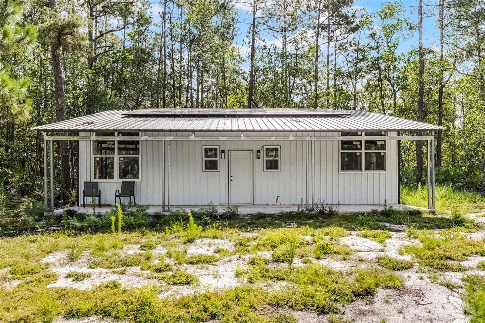 Dream Big on just under 7 Acres! Barndominium + Pole Barn Already in Place! Located in desirable New Smyrna Beach, unlock the potential of this unique opportunity: 2 combined lots just under 7 acres of build-ready land with well & septic, perfect for your dream home, private retreat, or multi-use homestead. Wooded property teeming with wildlife - deer, hogs & more - offering a true country lifestyle minutes from the coast. Includes a 1,200 sq. ft. Barndominium featuring solar panels with 20kW battery storage, framed for 2 bedrooms, 1 bath, tankless water heater, 2-inch spray foam insulation & propane gas. You will also find a 1200 sq. ft. pole barn with its own bathroom ideal for storage, a workshop or future conversion. FPL has already installed a power pole, & electricity to the property (just needs final hookup to the meter box). Zoned Rural w/Residential land use, this expansive parcel offers plenty of space for all your toys-RV's, boats, ATV's & more, w/no HOA to limit your freedom. Owner is currently in the process of combing 2 Parcels, see documents in attachments. See today!