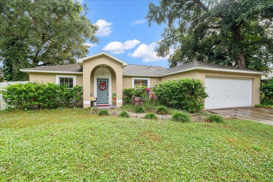 Situated on a sprawling lot with mature shade trees, this beautiful 3 bed/2 bath home is set to impress! Inside, the updated kitchen provides a welcoming, hospitable atmosphere, featuring Brazilian granite counters and stainless steel appliances. Throughout the interior, dark hickory 8mm laminate creates a rich, cohesive look that's both durable and stylish. High ceilings, lots of storage, neutral colors, contemporary fixtures, great laundry space — this home has it all! Are you checking your list twice? Because additional desirable upgrades include a newer roof, HVAC, and water heater (all 2019). With a private-yet-convenient, HOA-free location, this house is fully ready to be your new home for the holidays!