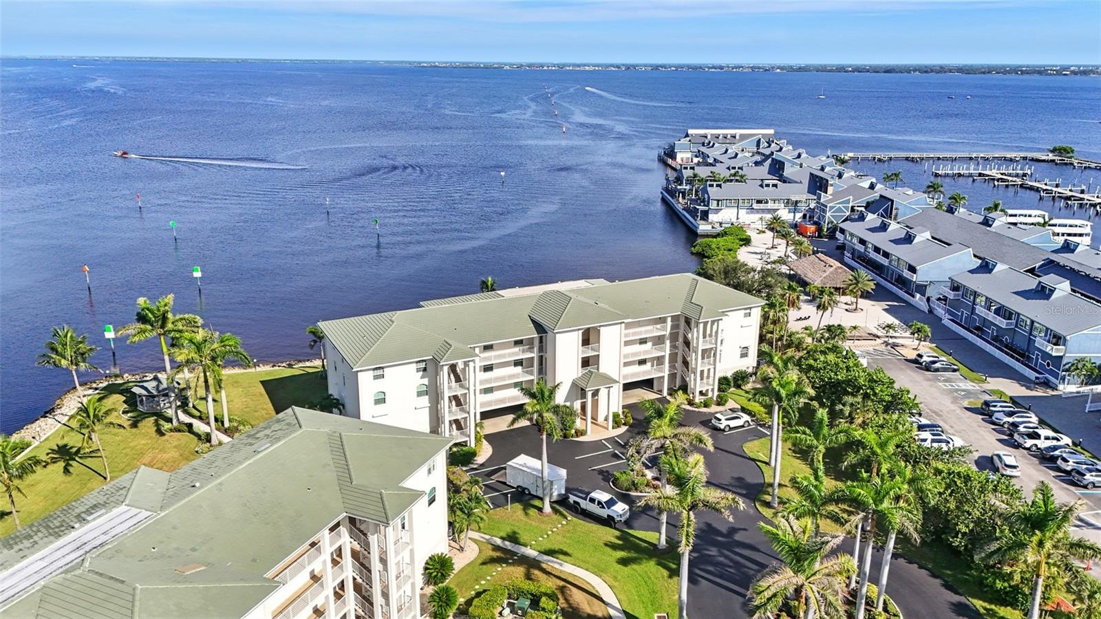 Prepare to be captivated by panoramic, 180-degree views of Charlotte Harbor from this stunning corner-unit penthouse—a rare opportunity to own a true piece of paradise. From the moment you enter, you'll be surrounded by custom finishes, abundant natural light, and the tranquil elegance of coastal living at its finest.
This spacious 3-bedroom, 2-bath residence offers a thoughtfully designed layout with oversized tile flooring, LVP flooring in the bedrooms, and soaring vaulted ceilings that enhance the open, airy feel. The expansive primary suite overlooks the water and features an updated modern bathroom with a dual vanity, vanity tower, walk-in tiled shower, and a large walk-in closet.
The gourmet kitchen features solid surface countertops, rich solid wood cabinetry, custom built-ins, and a designer tile backsplash. A convenient pass-through window opens to the fully enclosed, climate-controlled balcony—an ideal space to take in stunning views of Charlotte Harbor. Whether you're entertaining guests or unwinding with a glass of wine, you'll enjoy watching boats glide by and taking in breathtaking sunsets each evening.
Enjoy year-round comfort and safety with hurricane-rated windows, brand-new hurricane sliders, and a whole-house water treatment system. Each room is equipped with a ceiling fan, while the separate laundry room includes a utility sink, drying rod, and extra cabinets for storage. And don't miss the oversized storage room with a workshop located next to your covered parking.
This one-of-a-kind penthouse combines luxury, location, and lifestyle—and is truly a must-see.
Don’t miss this opportunity to own a show stopping penthouse overlooking Charlotte Harbor. Schedule your private tour today! CHASING SUMMER