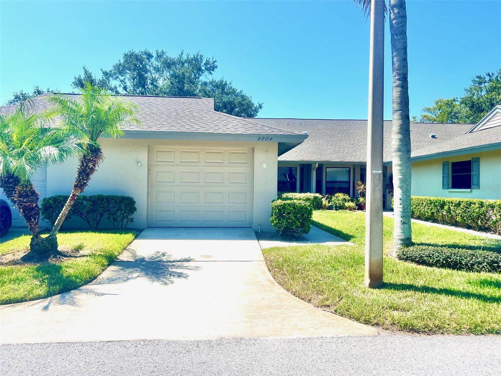 A welcoming Updated Villa on the Golf Course is for sale now in the sought after Community in New Port Richey/Trinity Florida area called Seven Springs Golf & Country Club! Come take a look and fall in love with all you have just a Golf Cart/bike ride or walk from the clubhouse. Inside the Clubhouse you will enjoy access to 2 Swimming Pools, Pickleball & tennis Courts, 2 Golf Courses, ongoing activities, Fitness Center, Restaurant & Bar, and much more! The 1 Level Block Villa located in the section called Golf View Villas V features & has Updates that include a Split Plan 2 Large Bedrooms, 2 Bathrooms, Roof replaced 12/2021, 2 Skylights, Vaulted Ceilings, 1 Car Detached Garage, Sunroom, A/C Replaced 2024, Upgraded Kitchen with nook area, Walk-In Closet, Water Heater replaced 2025, Laundry hookups in the Garage, Whole Home Water Softener, and more. The spacious primary bedroom features an en suite bath and a generous size walk-in closet. This Villa is charming and well maintained and ready for you to buy with cash or conventional financing. **The Fees you pay monthly cover a lot such as the Roof, Exterior Care & Maintenance, Internet, Water, Sewer, Trash, Basic Cable, & Pest Control** Also the social membership is included in the monthly fee. Ready to enjoy all that Florida has to offer? This is the Villa for you. Seven Springs Golf & Country Club community is centrally located near all shopping, Places of worship, Restaurants, main roads to get you to Florida Beaches, Airports, Downtowns, The Outlet Mall, Universities, Sports Complexes, and much more. Sold ASIS and no Flood Insurance is required. all to reside must be over 16 years old here. Give us a ring now on this Priced to Sell Villa and make this your Homestead!