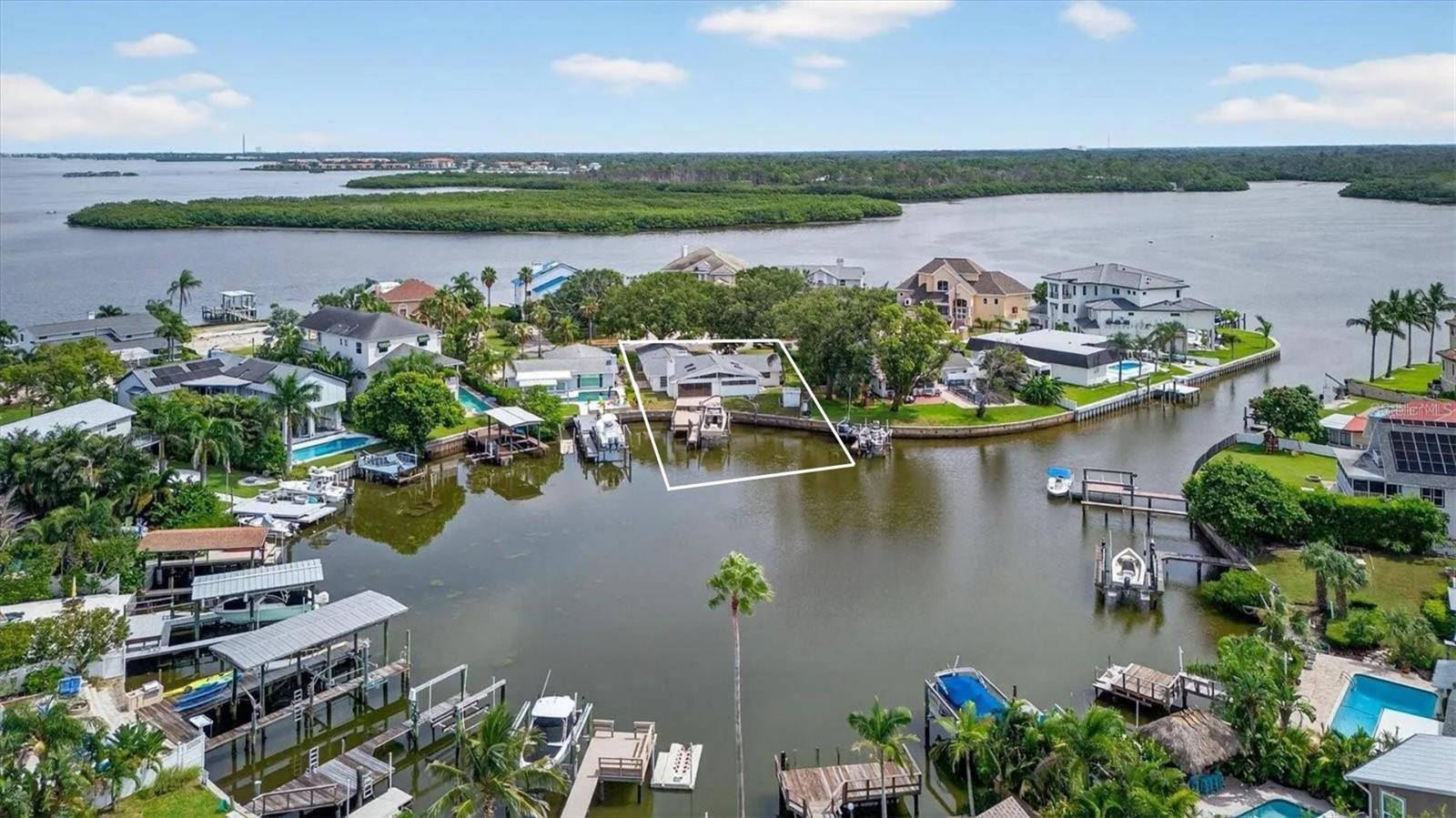 Welcome to INDIAN BLUFF ISLAND, where it's all about INSTANT EQUITY & LOCATION!!! This rare WATERFRONT gem offers DIRECT GULF ACCESS and sits in a quiet CUL-DE-SAC just seconds FROM THE GULF OF MEXICO where there is ENDLESS WATER ADVENTURES—jet skiing, boating, fishing, kayaking, paddleboarding, and more! Expertly remediated after recent storms, and redesigned to comfortably fit 4 Bedrooms/ 4 Bathrooms & a Bonus Room, this home features all-new drywall, updated electrical, and a BRAND-NEW ROOF (JUNE 2025), this home is ready for its new owner to plug and play by ADDING THE COSMETIC FINISHES of their dreams. Featuring grand CATHEDRAL CEILINGS with breathtaking WATER VIEWS, TWO FIREPLACES in the Formal Living Room & Family Room, and 2 ADDITONAL BONUS SPACES perfect for a home office, man cave, library, or even a 4th and 5th bedroom—this property has ENDLESS POTENTIAL! The PRIVATE DOCK with 20,000lb BOAT LIFT AND 8-YEAR-OLD SEAWALL make it a BOATER’S PARADISE, and with homes in the area selling for $3M+, you’ll be tapping into INSTANT EQUITY the moment you move in. CASH, CONVENTIONAL, RENOVATION, FHA 203K’S, OR HARD MONEY OFFERS ARE ALL WELCOME! This is your chance to CREATE YOUR ULTIMATE WATERFRONT DREAM home at a steal—before it’s gone!