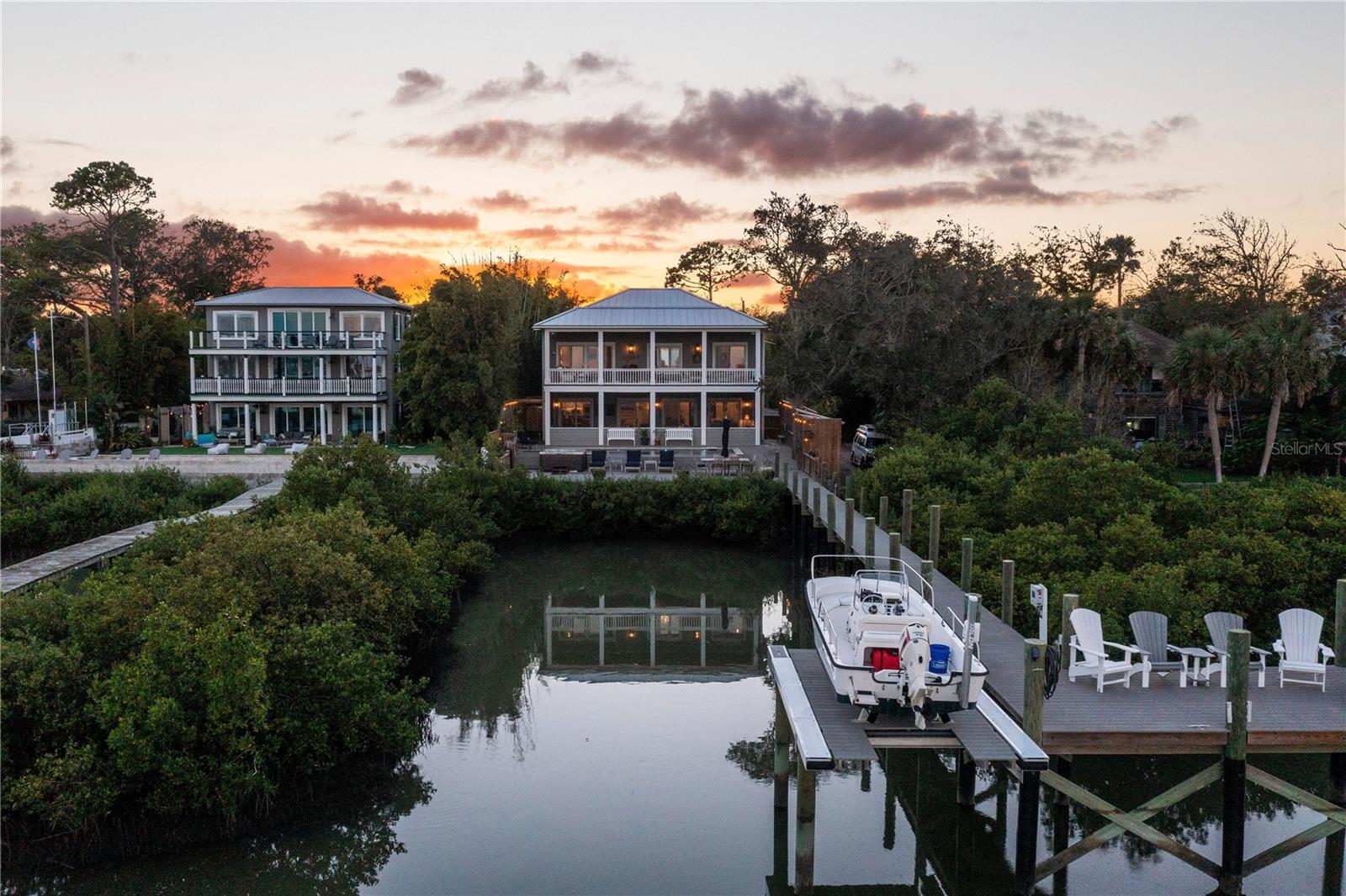 Experience waterfront luxury in this St. Augustine home, perfectly poised on the Intracoastal, offering unobstructed views of the city’s treasures. From the sparkling Intracoastal waterway to the historic landmarks like Porpoise Point, Vilano Bridge, and the iconic Lighthouse, this property captures St. Augustine's essence. Rebuilt in 2020, this home seamlessly blends historical charm with modern elegance. No expense was spared during the renovation; every corner exudes quality. The open-concept design connects the living room, dining area, and gourmet kitchen, all overlooking the mesmerizing outdoor space. The kitchen, a chef’s dream, features a gas range, Wolf appliances, and a charming whitewash brick backsplash. Above the garage, a versatile space serves as a game room or a fourth bedroom, perfect for entertainment.
Upstairs, three bedrooms and two full bathrooms await. The primary bedroom offers a spacious sanctuary with walk-in closets and balcony access for sunrise views over the water. The ensuite bathroom is a luxurious retreat with a soaker tub, double vanity, and a standalone shower. The garage, a rarity in downtown St. Augustine, is equipped with temperature control and water supply, ideal for hobbies.
Outside, an infinity pool and hot tub offer relaxation against the Intracoastal backdrop. Trex Decking extends to the backyard/dock, complementing the outdoor shower and no-profile boat lift, making this a boater's paradise. Imagine enjoying 4th of July fireworks from your private dock or strolling to restaurants and shops. This home embraces St. Augustine’s essence, offering a lifestyle beyond compare. Don’t miss this chance to own historic charm, modern luxury, and waterfront marvels.