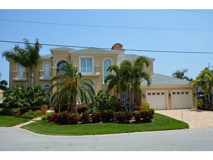 One home in from Sarasota Bay. *SPECTACULAR* Bay Views. Comforts include master suite with HUGE walk-in closet and luxurious master bath. The second floor which also incudes 2 additional guest suites and a media room is serviced by an elevator as is the 2 car garage. The living room has 2 sets of french doors , and a gas fireplace. There is also a formal dining room. The gourmet kitchen with Viking appliance, gas 5 burner stove, center island with prep sink and wine refrigerator features beautiful wood cabinets and granite counter tops. The family room is open to the kitchen and beyond is the den/office. There is a heated pool and spa. A composite material deck with a 13,000lb boat lift and an additional 16,000 lb boat lift as well as lifts for two jet skis. And to make the entertaining even more enjoyable is the outside kitchen. You also enjoy beach access to the beautiful beaches of Longboat Key. Minutes to St. Armands Circle where you will find excellent shopping and restaurants. Sitting on the southern end of Longboat Key, Country Club Shores with its deep sailboat water canals and extraordinary bay views remains one of Longboat Key's most sought after addresses. This community of single-family homes is set on 19 streets, each with a distinctive nautical or golf-related names. The homeowners' associations oversee the distinctive common areas as well as a variety of social events.