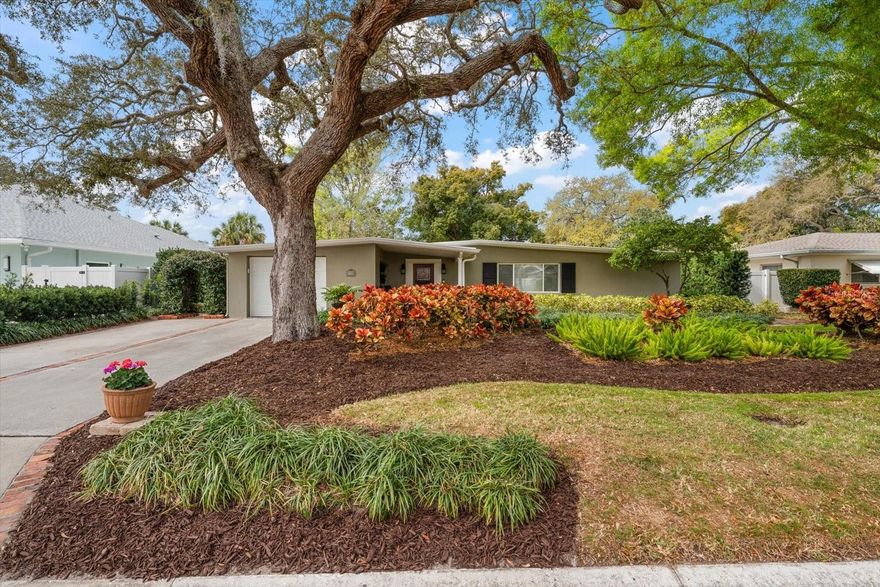 Nestled on a quiet Belleair street, this beautifully renovated and move-in ready home welcomes you with charming curb appeal, professional landscaping, and a brick walkway leading to the front door. Inside, warm wood floors and thoughtful updates create an inviting atmosphere. The custom kitchen is designed for both function and style, featuring granite countertops, abundant prep space, a breakfast bar, stainless-steel appliances, a built-in ironing board, and a skylight that fills the space with natural light. The adjoining living and dining room combination offers an easy flow for everyday living and effortless entertaining. The primary suite includes a private ensuite with tub/shower combo and another skylight for added brightness, while additional bedrooms share a well-appointed hall bath with a walk-in shower. Step outside to a true showstopper—an incredible backyard oasis made for enjoying Florida’s beautiful weather and hosting gatherings year-round. With a new roof in 2024, walkability to local restaurants and shopping, a short bike ride to the sparkling beaches, and convenient access to two airports, this Belleair gem offers comfort, location, and lifestyle—and won’t last long.