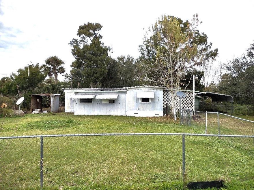 Discover the potential in this 1970 single wide mobile home with additions, offering a comfortable layout and plenty of outdoor features. This 2 bedroom, 2 bath home includes a large living room, dedicated dining room, and a functional kitchen, providing ample space for everyday living. The spacious master bedroom offers room to relax, while the second bedroom is perfect for guests, an office, or hobby space. Enjoy Florida living with a screened porch and back porch, ideal for morning coffee or evening gatherings.  Outside, the property features a 2-car carport, storage shed, and a partly fenced yard, offering space for pets, projects, or additional storage. This property is being sold As-Is, making it a great opportunity for buyers looking to customize or invest.  Seller may consider seller financing with $30,000 down, making this an excellent option for buyers seeking flexible terms.  Whether you’re looking for an affordable primary residence, rental opportunity, or investment property, this home offers value and potential. Schedule your showing today and explore the possibilities!