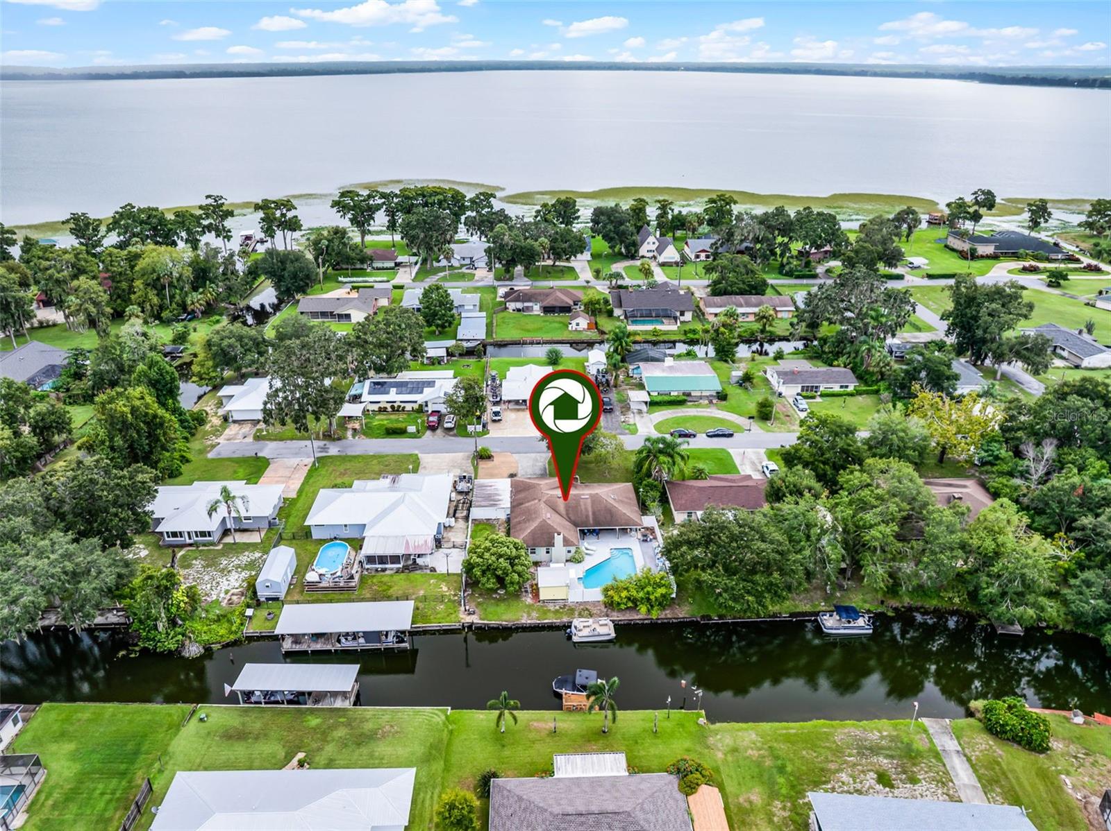 Welcome to this beautiful 3-bedroom, 2-bath pool home, perfectly situated on a premium canal-front lot with picturesque views and direct access to the tranquil waters of Lake Pierce.
As you arrive, you’re greeted by an epoxy-finished covered front porch adorned with a glass storm door. Inside, the spacious living room features large double-pane windows that bathe the home in natural light, while sliding glass doors open directly to the poolside patio. Solid surface flooring runs throughout the main living areas, ensuring both durability and easy maintenance.
The eat-in kitchen is a chef’s delight, offering white cabinetry with soft-close hinges, granite countertops, and a stylish tile backsplash. A breakfast bar provides additional seating for casual dining, while a suite of updated stainless steel appliances caters to all your culinary needs. A convenient closet pantry and dedicated coffee station add both function and charm.
The great room is anchored by a cozy brick fireplace, complemented by crown molding that enhances its warmth and character. Nearby, the formal dining room features oversized sliding glass doors showcasing lovely pool views—perfect for entertaining.
The primary suite offers a tranquil retreat with a neutral color palette and a walk-in closet outfitted with a custom organizer system. The en-suite bath is designed with comfort in mind, featuring a skylight, oak comfort-height vanity with bronze fixtures, and a seated walk-in shower within the water closet, along with direct access to the patio.
Step outside to enjoy an oversized patio overlooking the pool—ideal for alfresco dining or relaxing in the Florida sunshine. A poolside composite deck and cabana provide additional entertaining space, perfect for hosting larger gatherings with family and friends.
Additional Features Include: Two generously sized guest bedrooms ,Freshly painted interior, Double-pane windows, Gutters, Epoxy-finished floors in patio & front porch, Leaded glass front door, HVAC system (2018), Washer & dryer included, Fenced-in yard, Two-car garage with keyless entry pad, Two-car carport.
For those who need extra space, this property offers ample off-street parking with two concrete driveways and an additional carport—perfect for boats, RVs, or trailers.
Lake Pierce spans an impressive 3,728 acres and is renowned for its premier fishing and boating opportunities. This is a rare opportunity to embrace the waterfront lifestyle you’ve been dreaming of. Surrounded by nature and offering modern comforts, this canal-front retreat is ready to become your new home. Furniture is negotiable